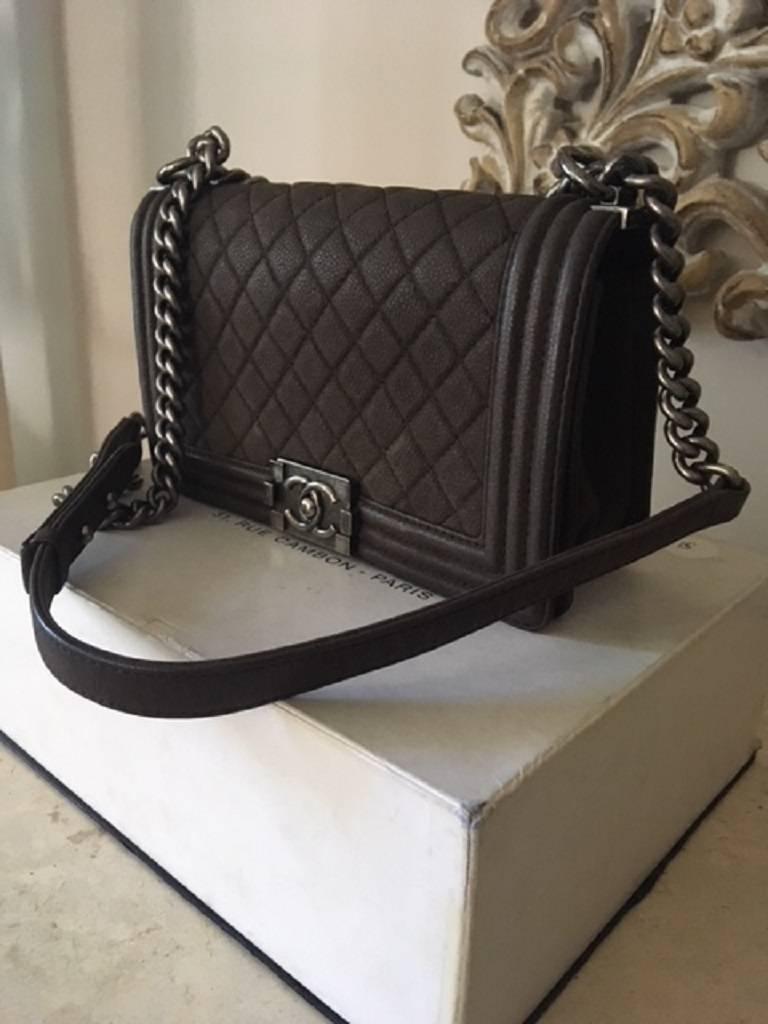 This boy bag has the very different and gorgeous suede quilted leather. The bag may look black but is in fact a brown colour. 
It is 100% Authentic and verified by LOLLIPUFF.   The bag comes with a certificate of Authenticity. 
This medium size boy