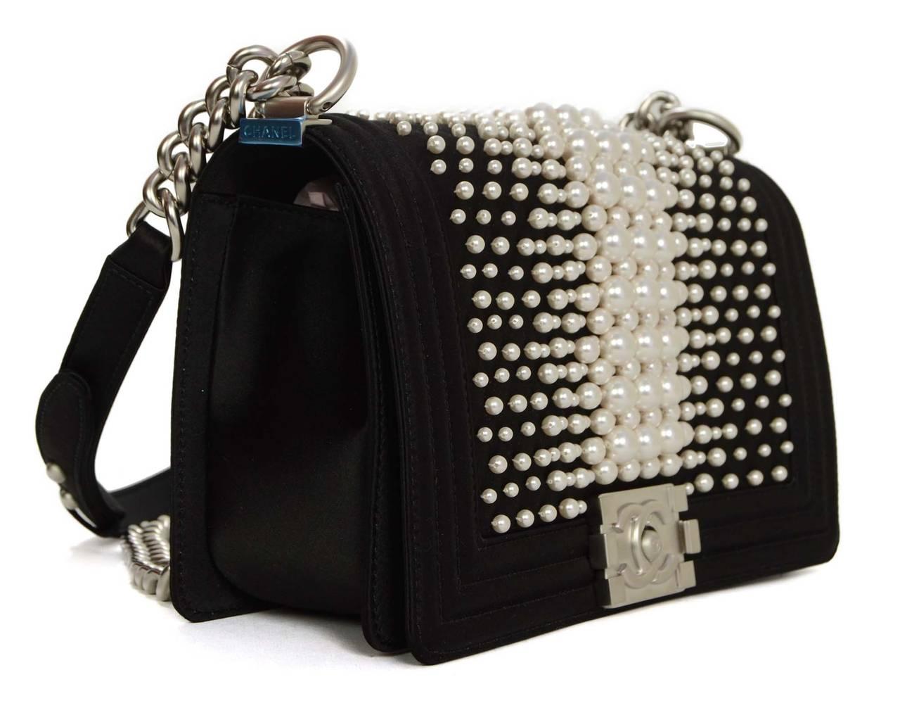 Brand New in box- store fresh with all the stickers still in tact from boutique. 

This beauty is the old medium size satin boy bag with satin pearl embellishments. 
  SOLD OUT WORLDWIDE. Limited edition

 On the outside of the bag is the gorgeous