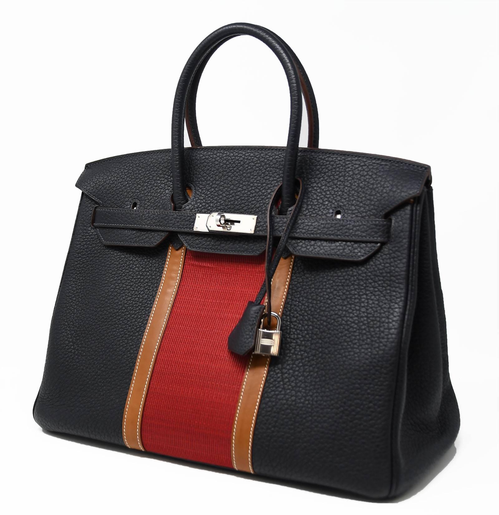 This tricolor Birkin bag is certainly a rare and coveted find.  A beautiful red stripe contrasts the black and tan leather.  Brand new with plastic on the hardware, this bag comes with the original dust cover.