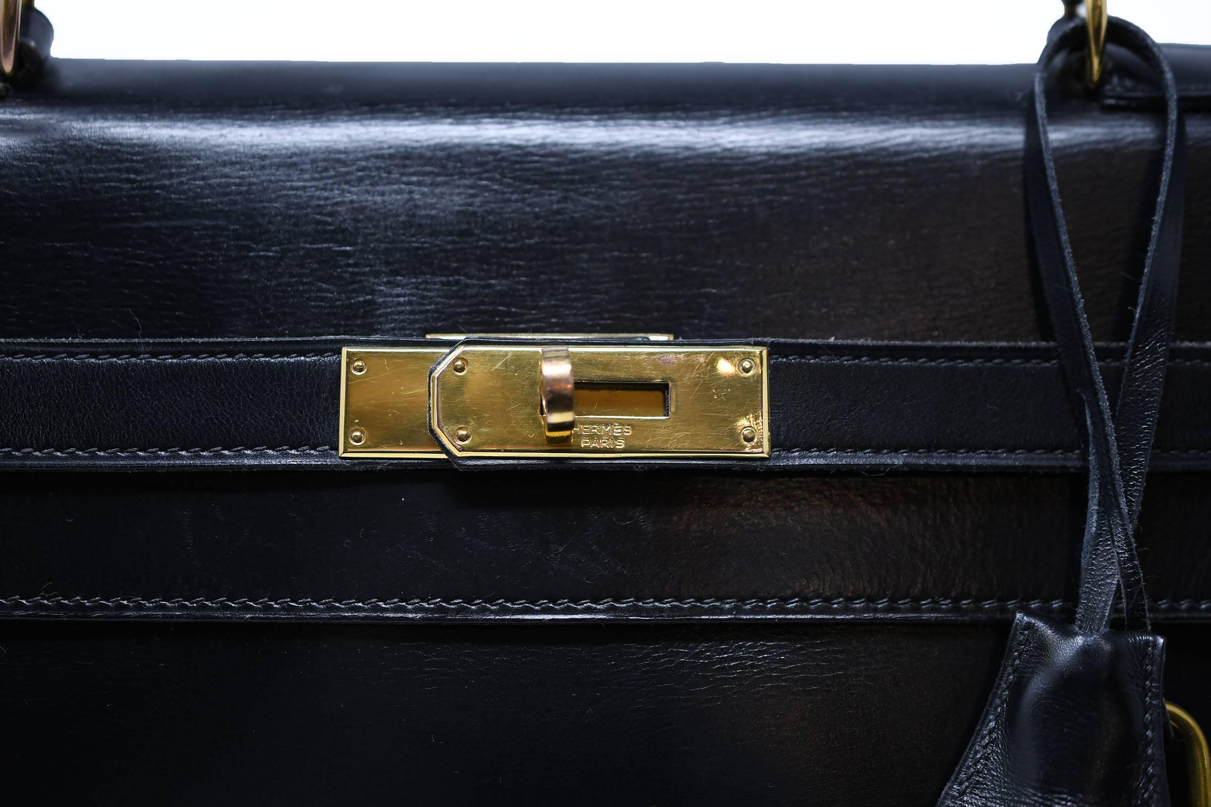 This vintage black Kelly bag epitomizes chic and classic.  The beautiful smooth box calf leather is accentuated by the gold hardware.  This bag comes with the original dust cover.  Very good vintage condition.