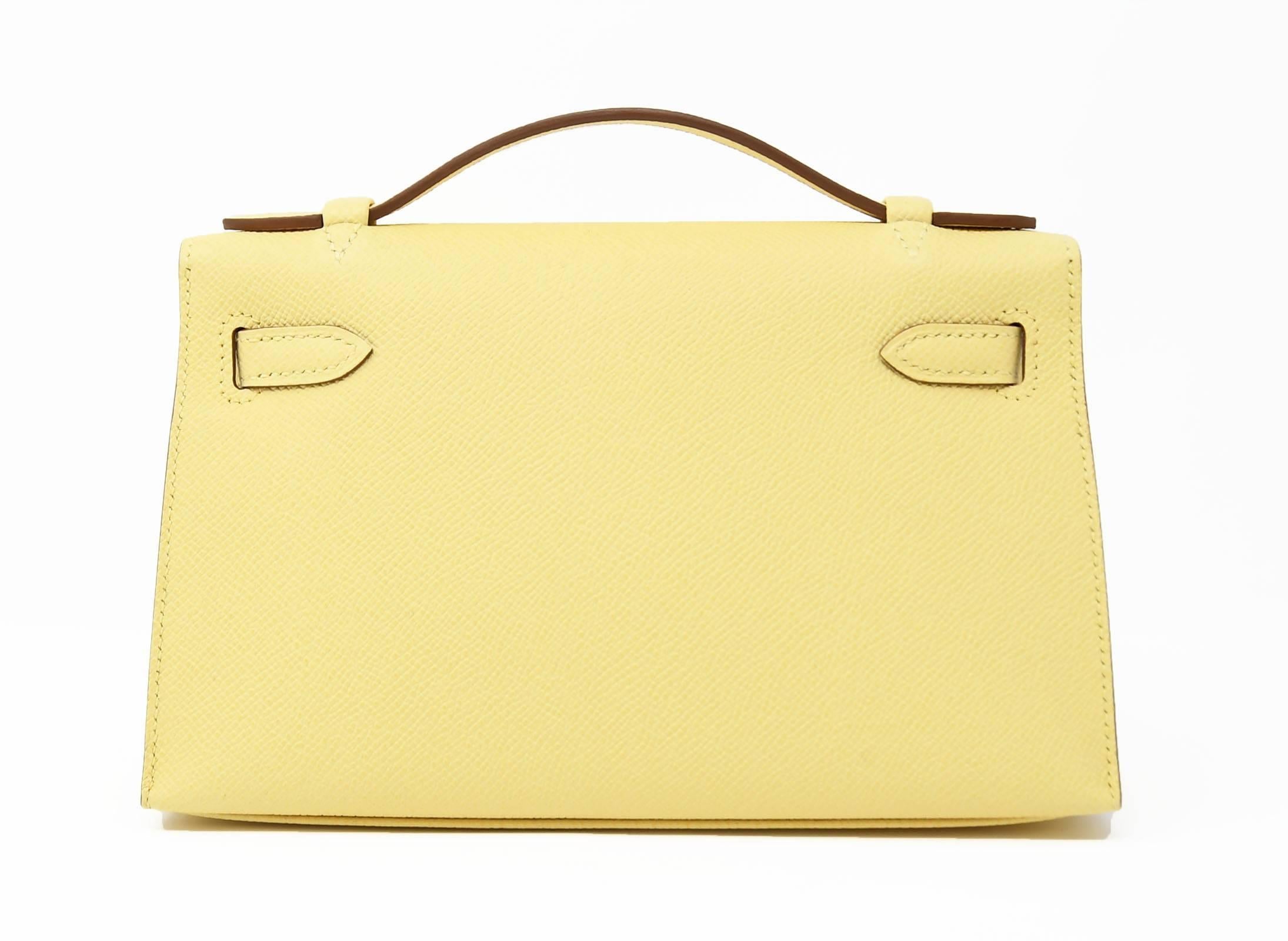 This light yellow kelly pochette is a perfect addition to any summer wardrobe.  A brand new item, with plastic on the hardware, also comes with the dustbag and box.  Looks great with an elegant outfit or dressed down with denim.