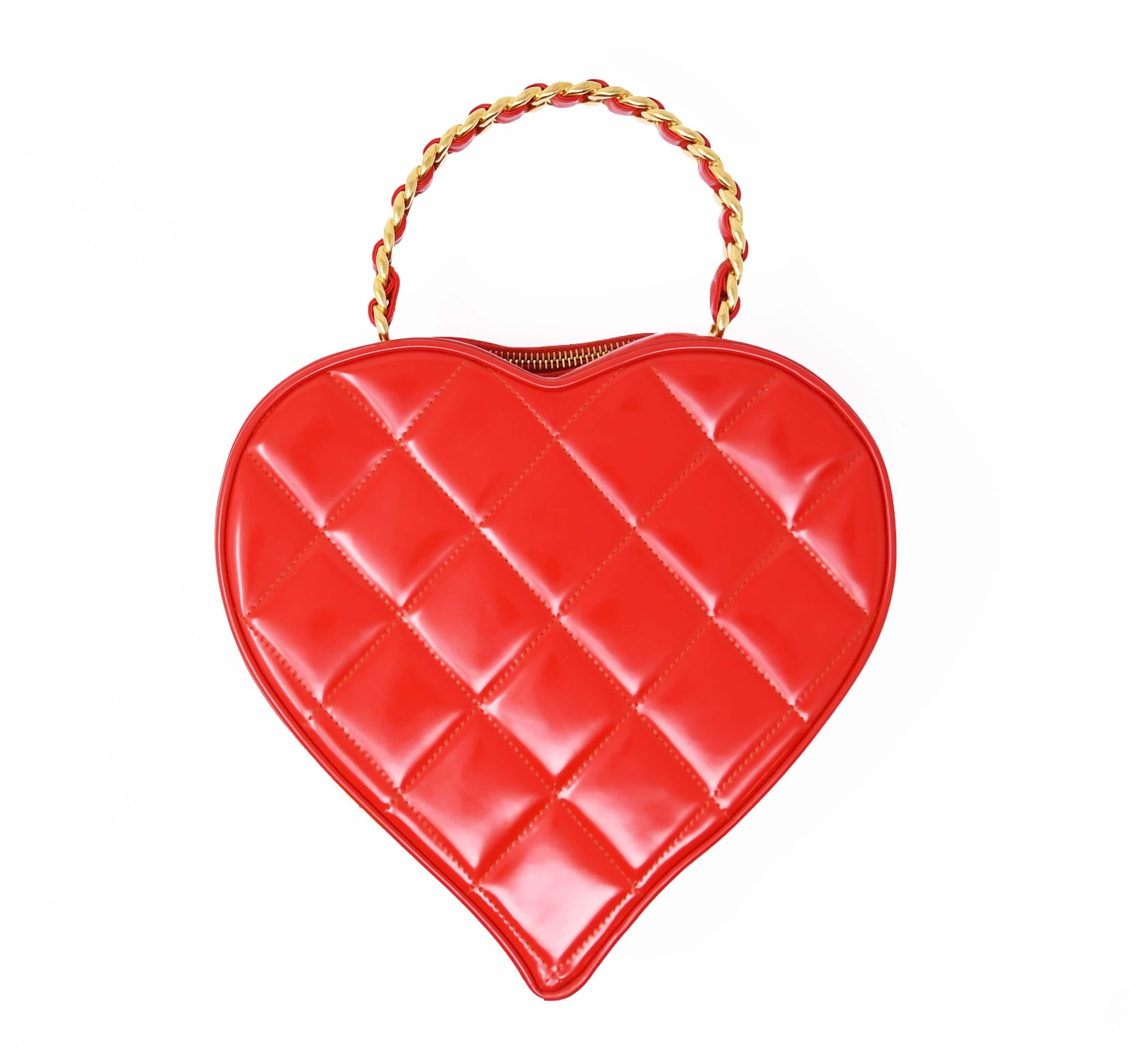 This Vintage Chanel quilted heart shaped bag is a limited edition piece from the early '90s.  Made of bright red patent leather with a black CC logo and gold chain handle.  A true collector's piece.

Condition: In excellent vintage