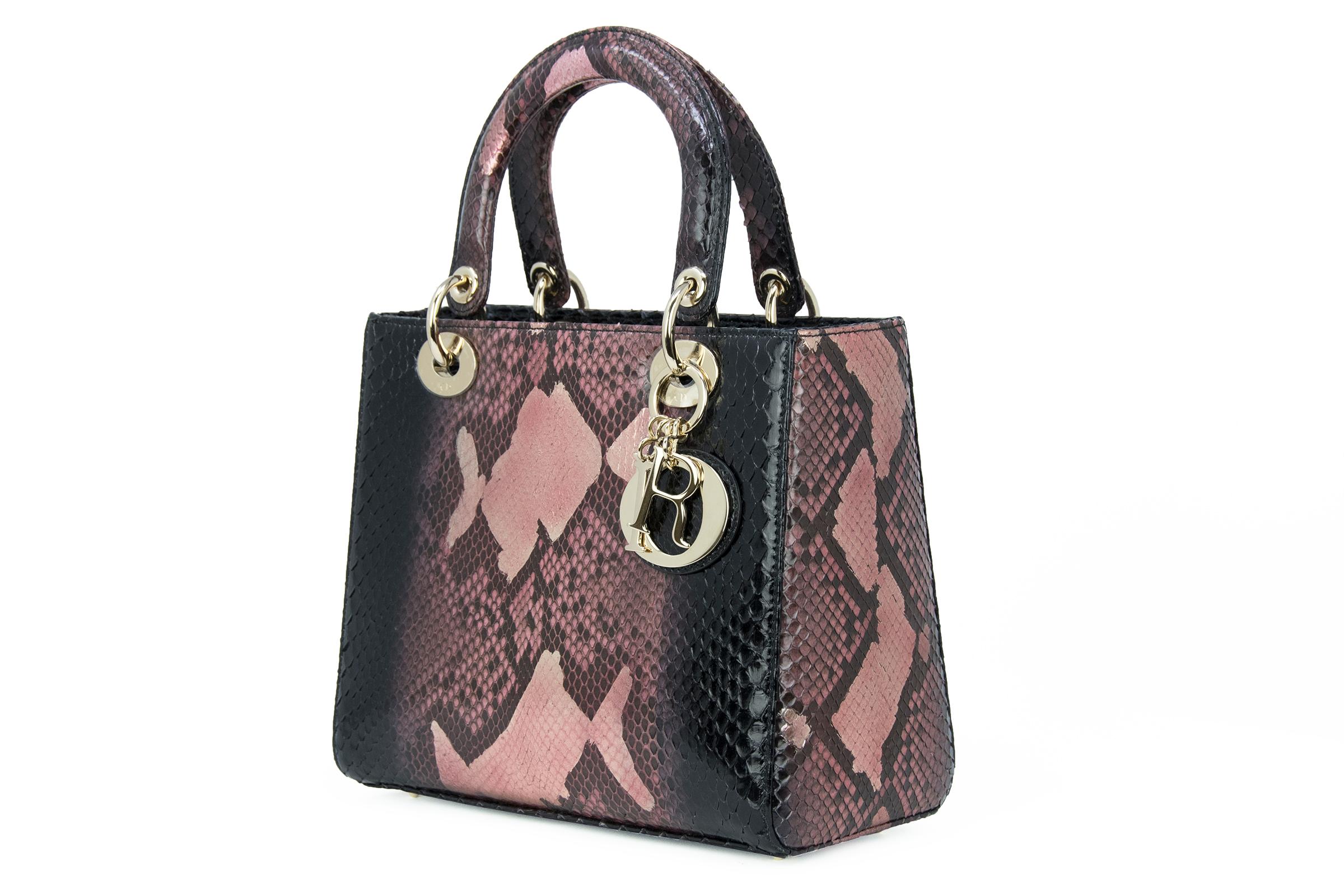 Incredible metallic python skin in hues of black and pink with gold hardware and top handles.  Features Dior letter charms that hang off the hardware on the handles. Rare to find this Lady Dior in a gorgeous snakeskin. 

Condition: In brand new