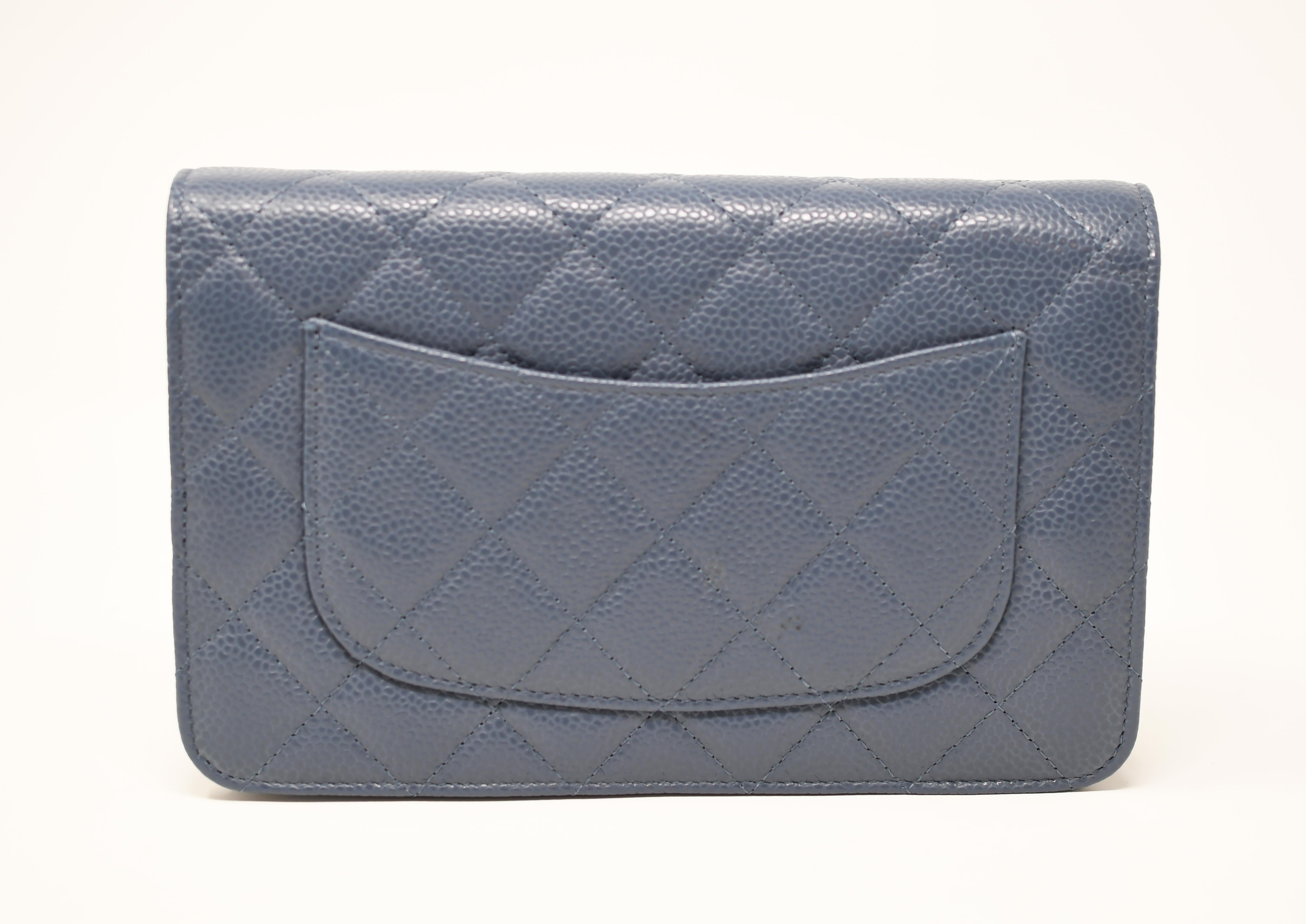 Classic Chanel chain shoulder bag in a gray/blue caviar quilted leather.  Features optional silver chain shoulder strap.  Silver CC on the front of the bag.  Credit card slots on the inside.

Condition: New with tags and comes in original box with