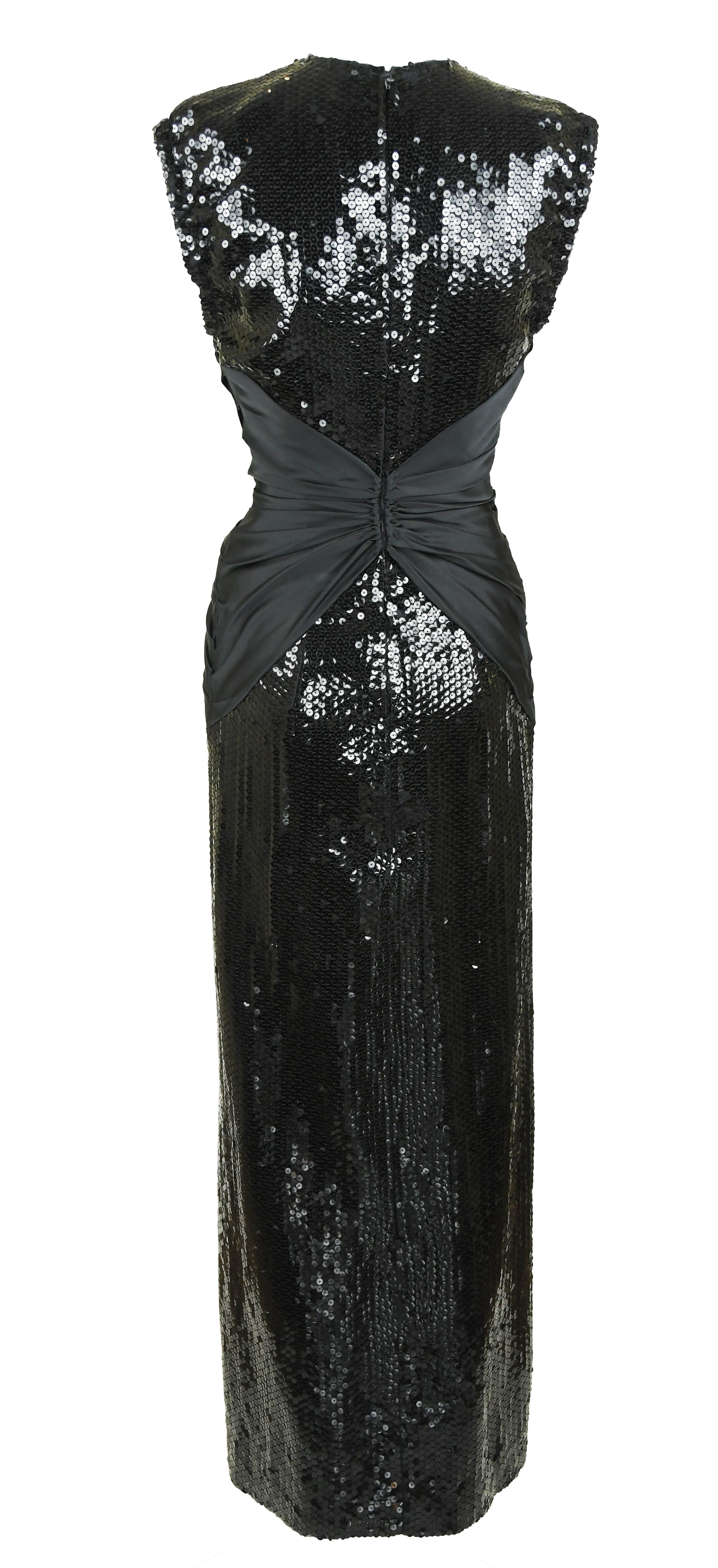 Stand out at your next black tie function with this incredibly rare and gorgeous vintage Azzaro gown.  Black sequins with a gathered black silk sash around the waist and a deep v neckline.

Size: No size but approximate S

Condition: Good vintage