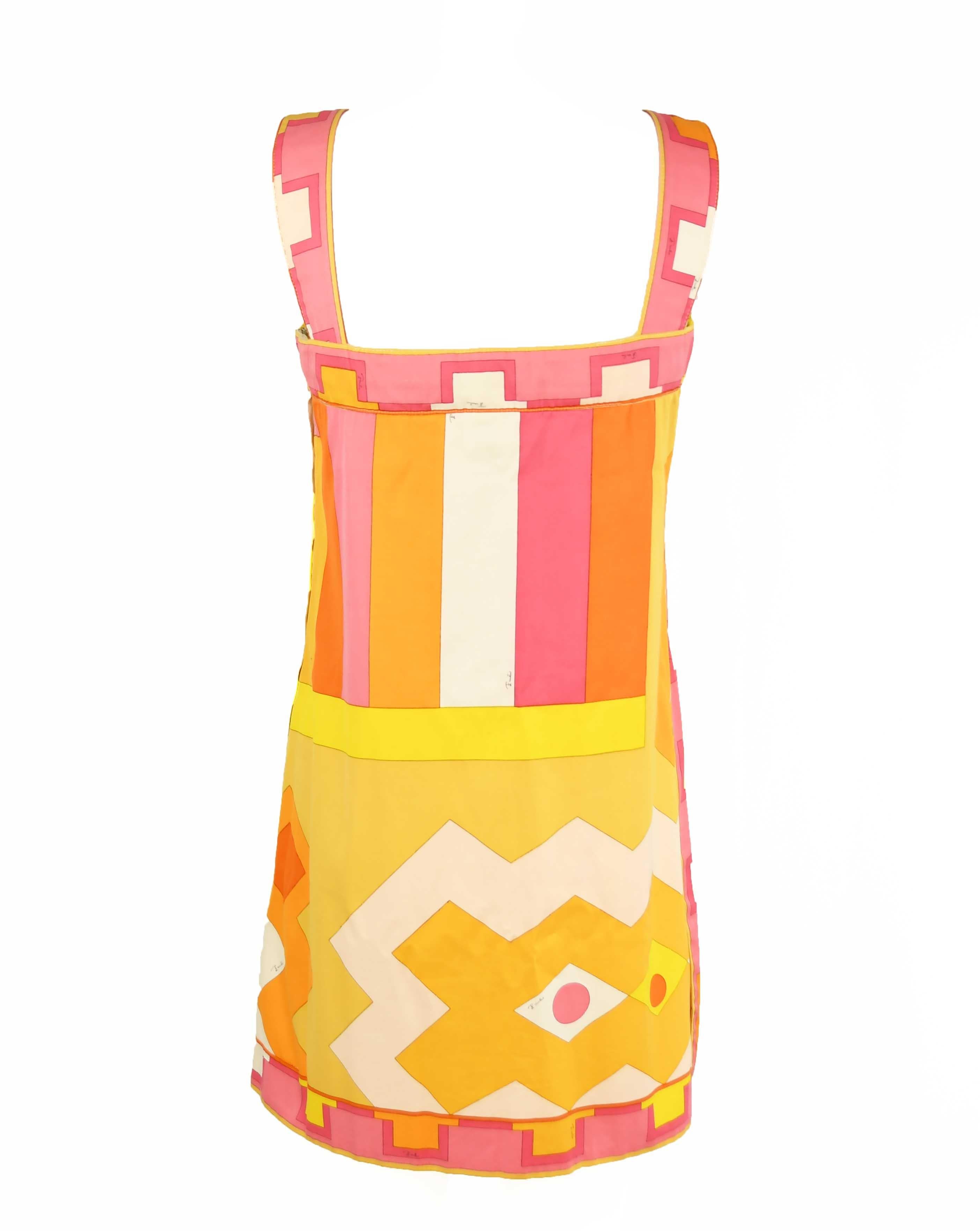 Classic vintage Pucci print in bright and vibrant yellow, pinks and orange.  Made of a twill fabric with an a-line silhouette. Perfect dress to throw on for summer.

Size: Labeled a vintage size 10, which fits approximately a modern size