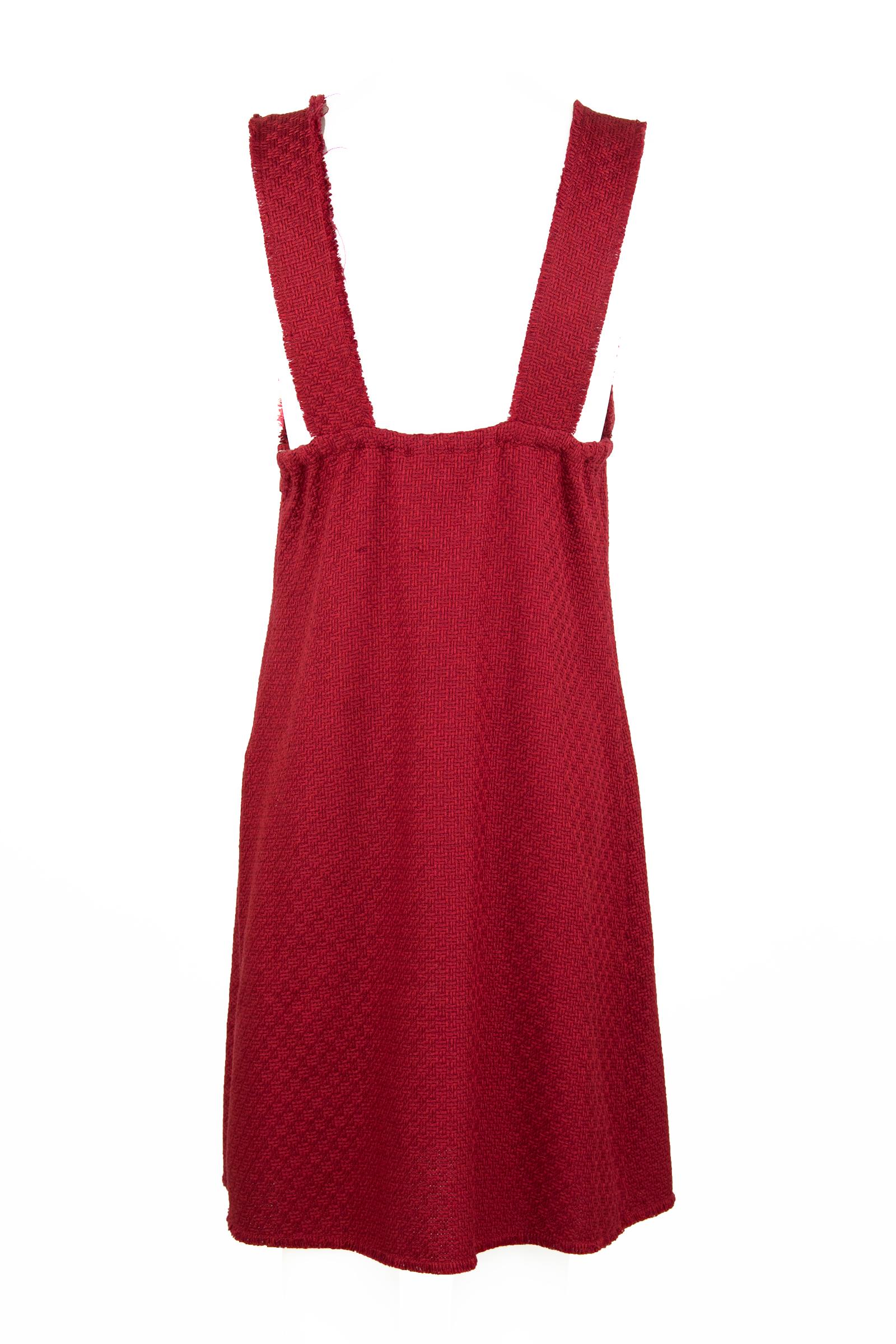 The perfect a-line Chanel dress to throw on for work or wear to a luncheon.  A cotton, wool blend in red with elastic under and around the bust for a snug fit.  Adorable red striped buttons with silver Chanel CC logos.  A perfect look for