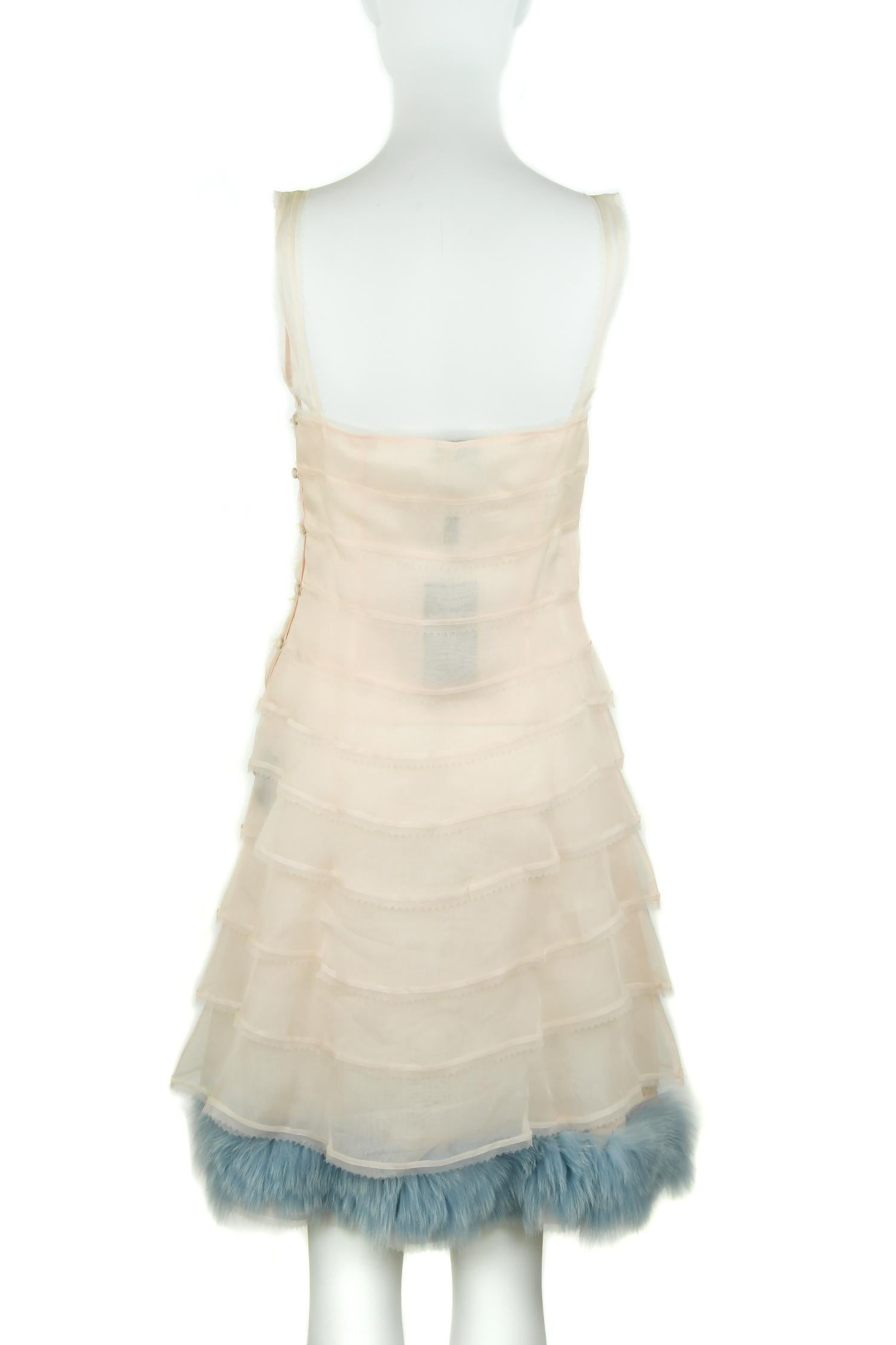 Absolutely incredible silk organza, in a very pale peach shade, with blue fur trim dress.  A line silhouette with tiers of organza with a picketed finish detail and a square neckline.  Classic and chic Fendi dress.

Size: IT 38

Condition: New with