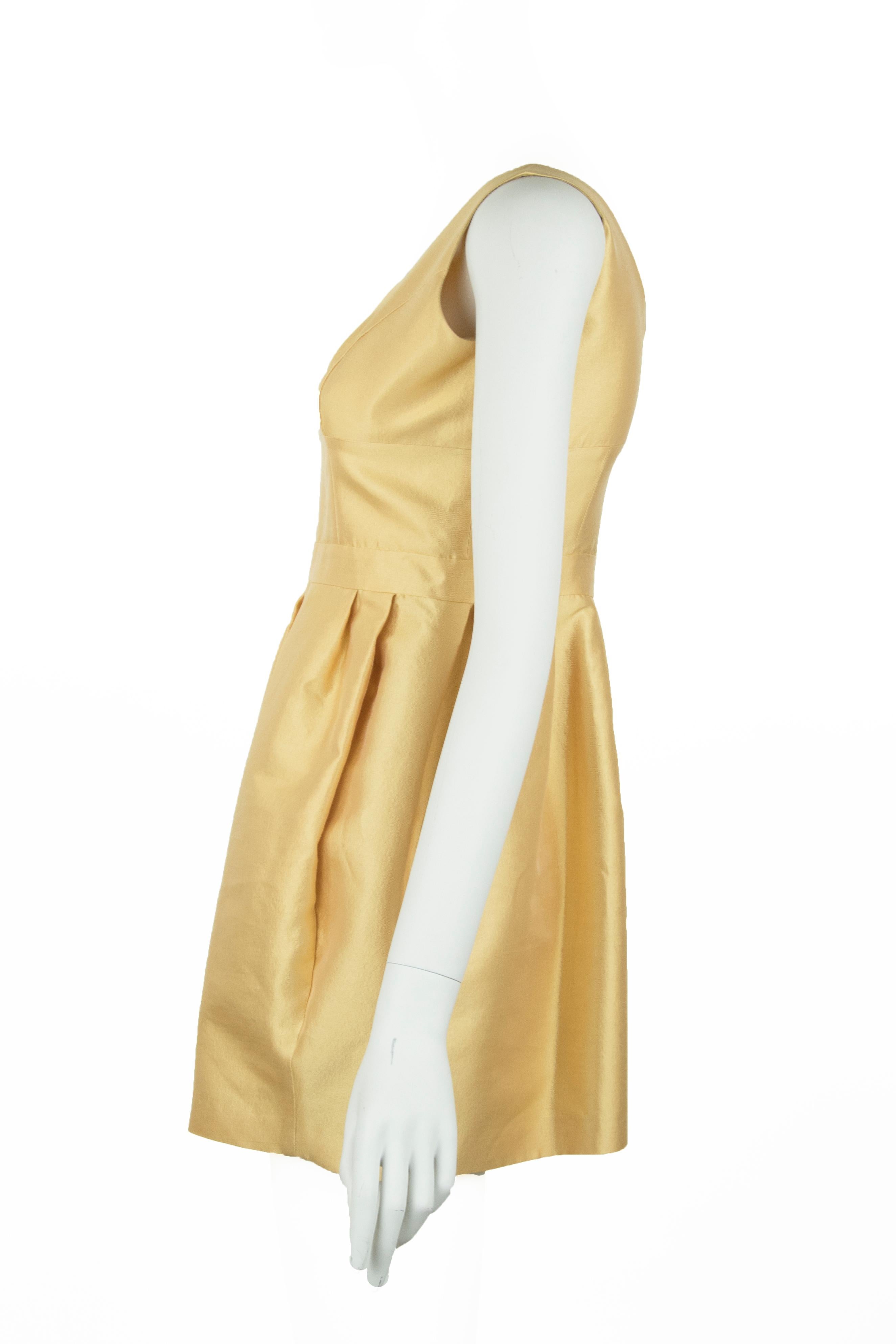 Classic scoop neck and gathered skirt on this prada yellow/gold colored silk and wool dress.  Mini dress length to show off some leg and make this classic look a little sexy.

Size: IT 42

Condition: Very good condition