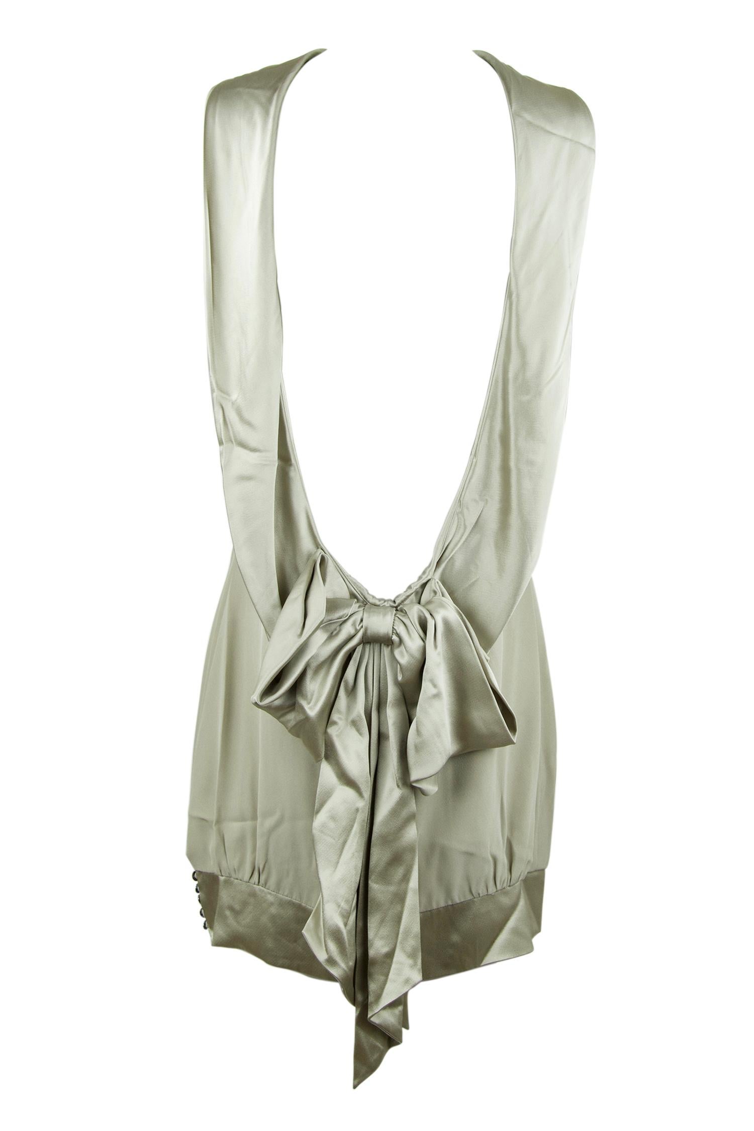 Stunning and sophisticated Loris Azzaro open back silk dress.  Features a high neck in the front with a charmeuse band with bow in the back.  Very elegant piece for your next cocktail party.

Size: No size tag but approximate S

Condition: Pristine,