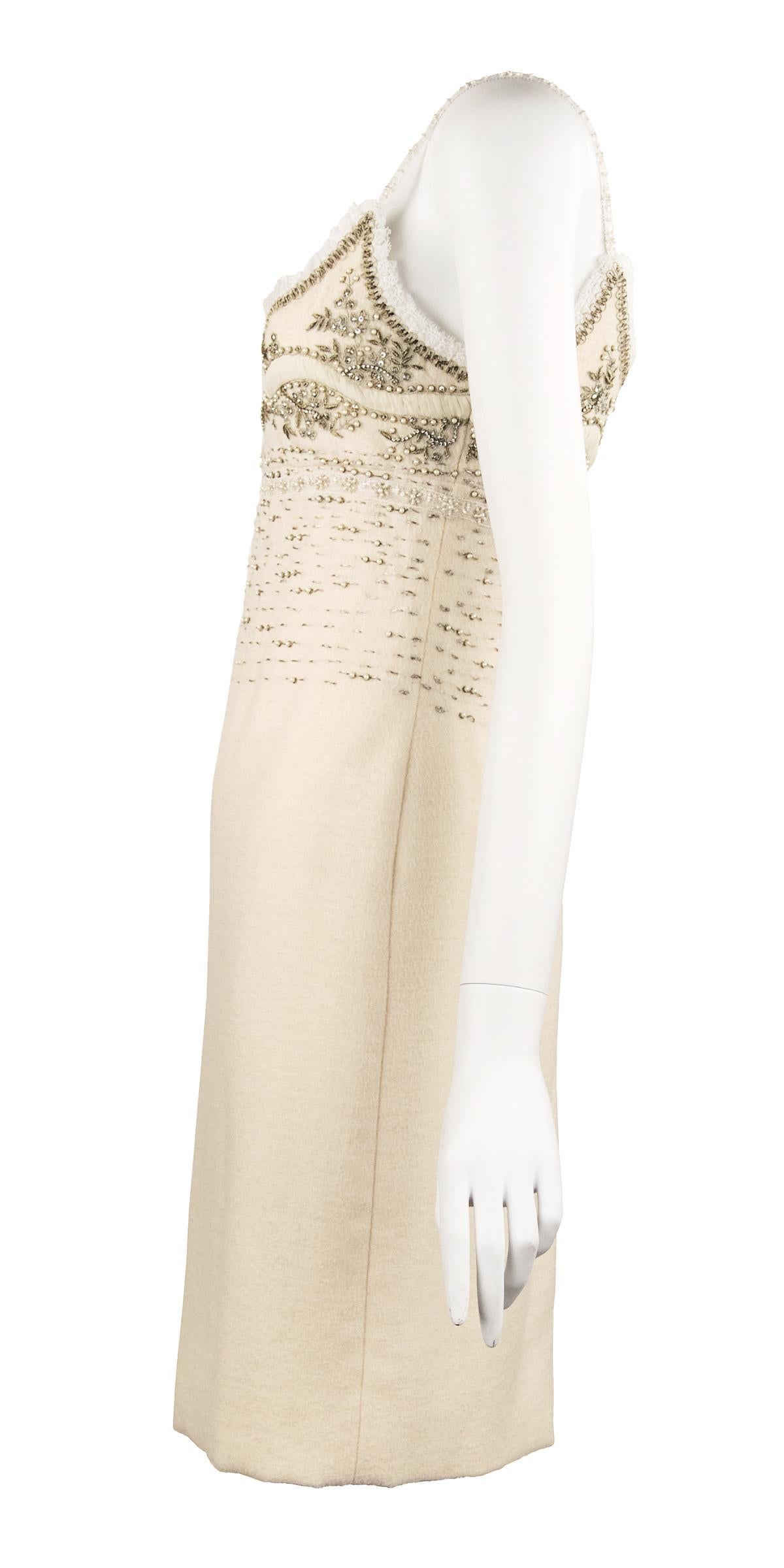 Clean and classic Oscar de la Renta wool ivory sheath dress with spaghetti straps.  Incredible embroidery composed of small faux pearls, beads and metallic thread.  In pristine condition.

Size: 4

Condition: Pristine

Composition: 93% wool 7% nylon