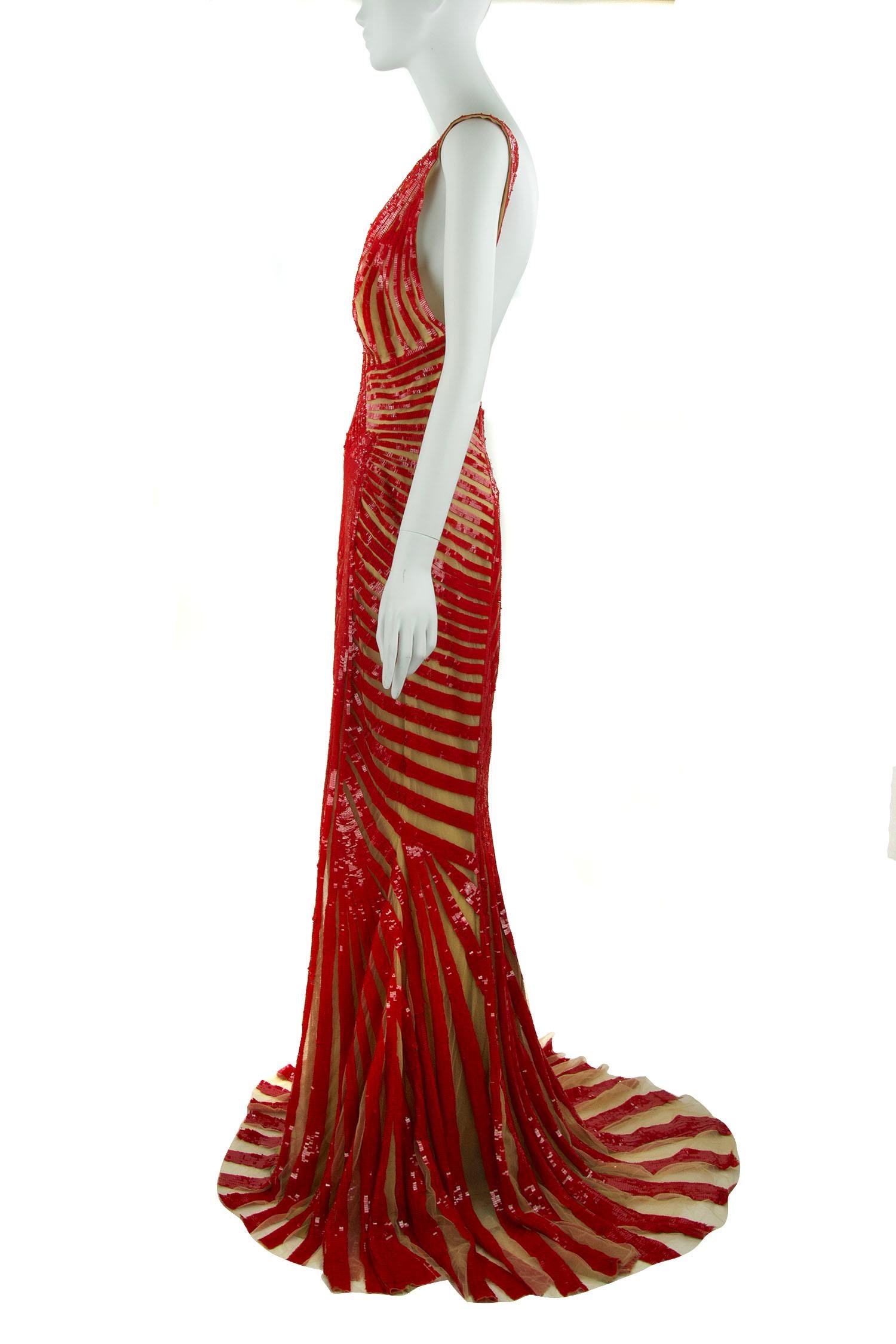 Look no further for the dress that will turn heads at your next formal event.  Incredible red beading making beautiful patterns and interesting detail down the gown.  With a very sexy open back, this piece is absolutely ravishing.

Size: US 4 &