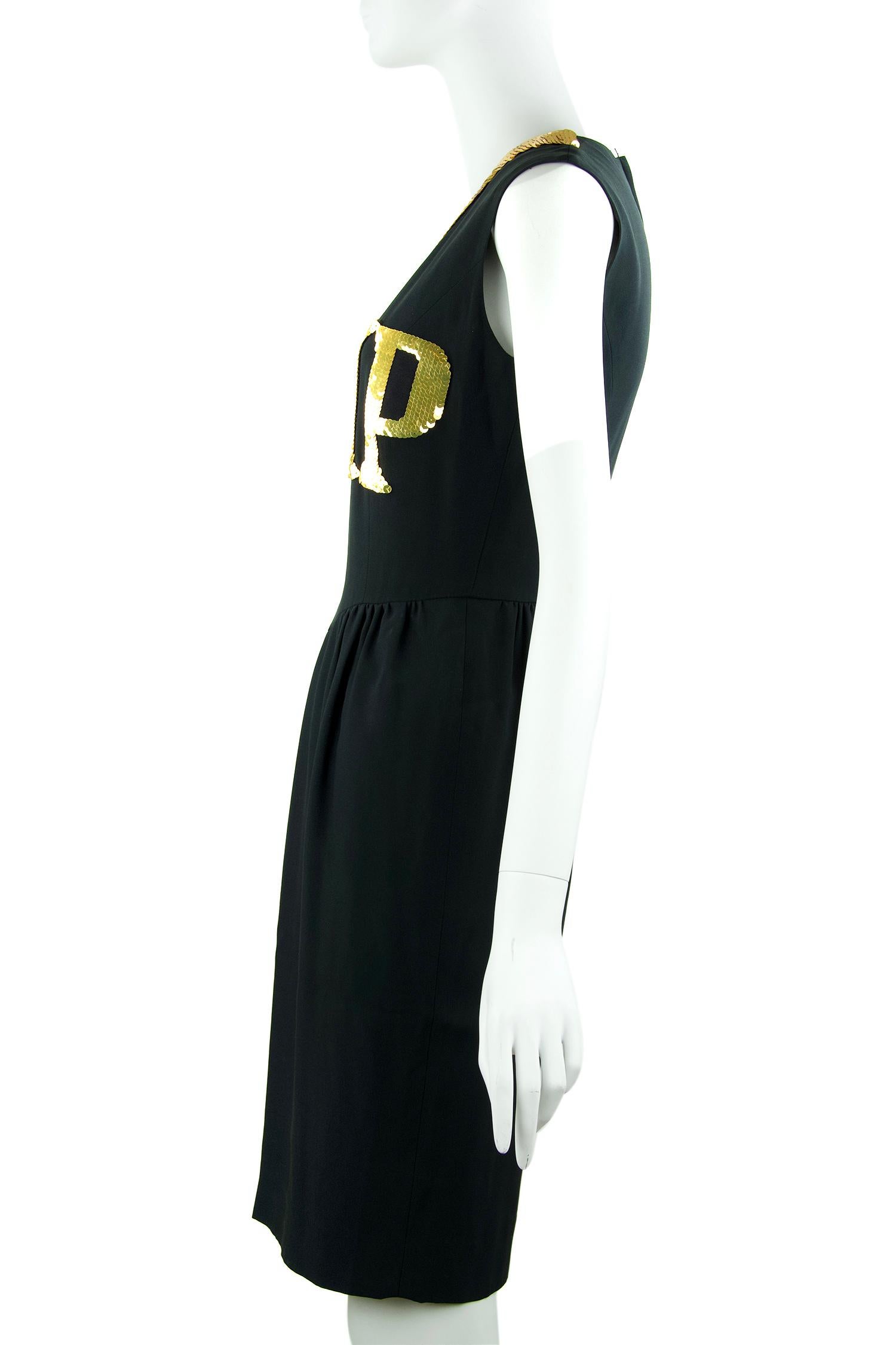 Iconic Moschino black sleeveless dress with gold sequin VIP detail.  Features a v neck and center back zipper.  

Size: XS

Condition: Pristine

Composition: 55% acetate, 45% rayon / lining 60% acetate, 40% rayon

Made in Italy