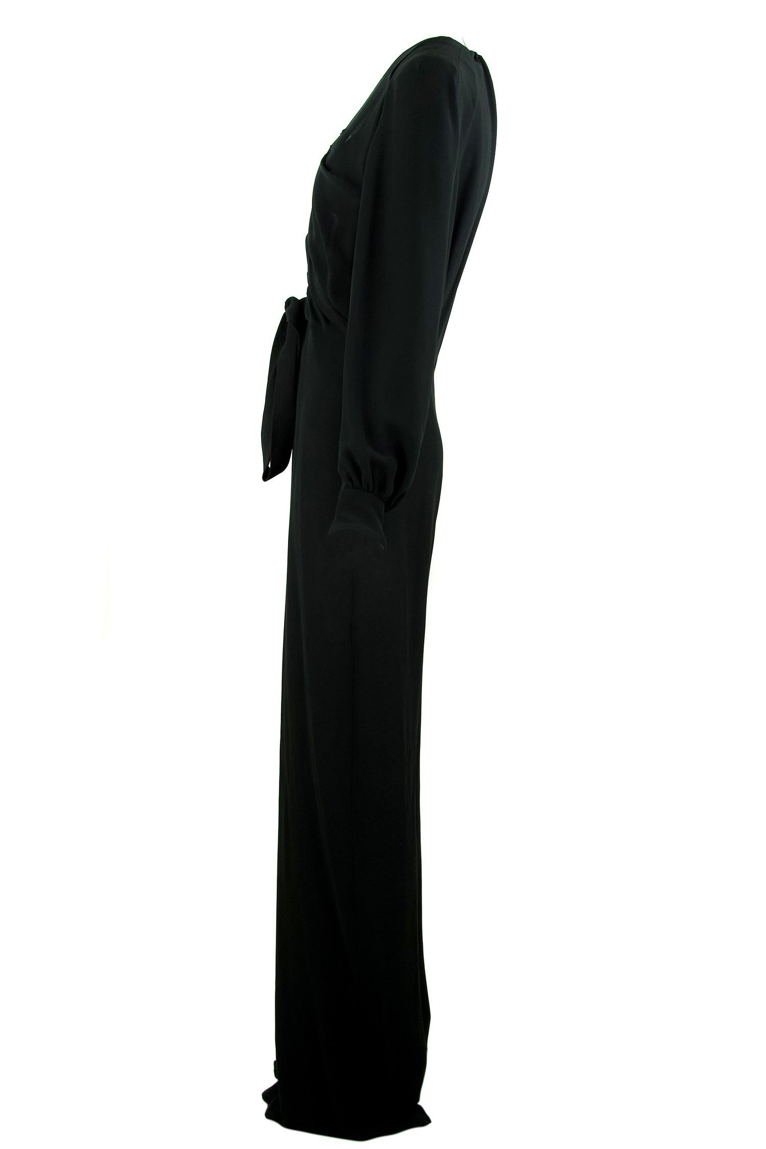 Chic and sexy Chloe long sleeve black jumpsuit.  Features gathered black silk fabric and a very low v neck with a tie at the bottom.  Gathering on the back and at the cuffs.  

Size: FR 40

Condition: Pristine

Composition: 100% silk

Care: Dry