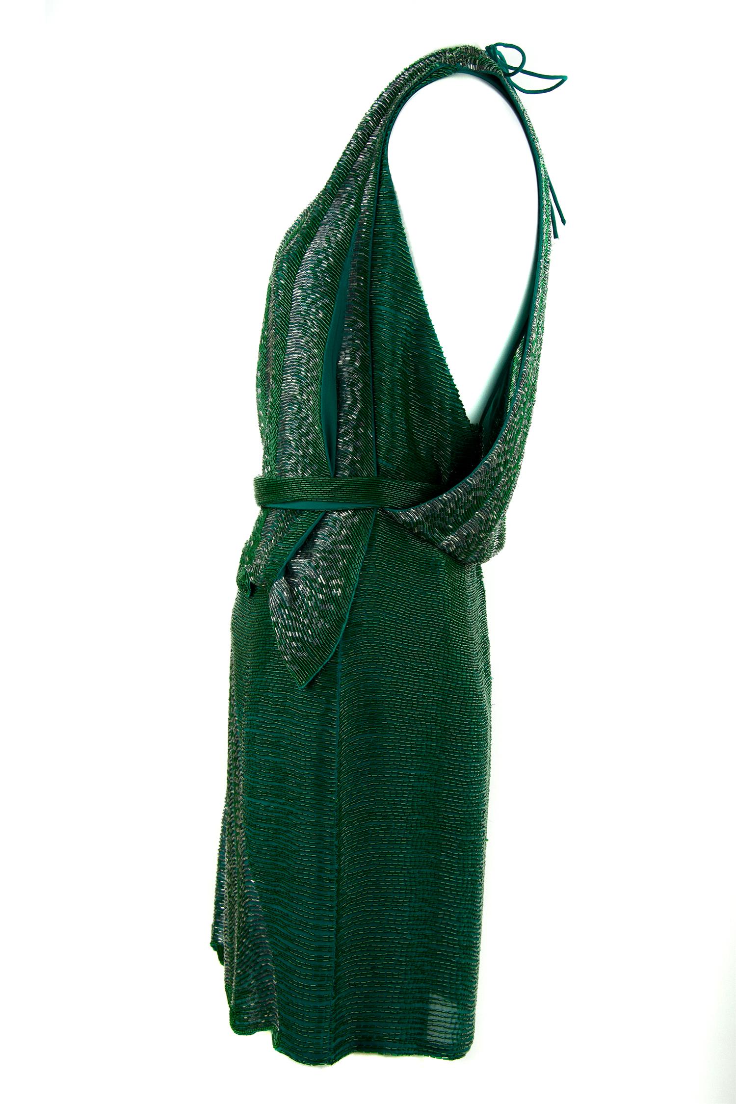 Heavily beaded deep green Roberto Cavalli dress with a sexy low v-neck and racerback style.  Features intricate detail and a belt to cinch the waist.  

Size: IT 40

Condition: New with tags

Composition: 100% silk / lining 100% viscose

Made in