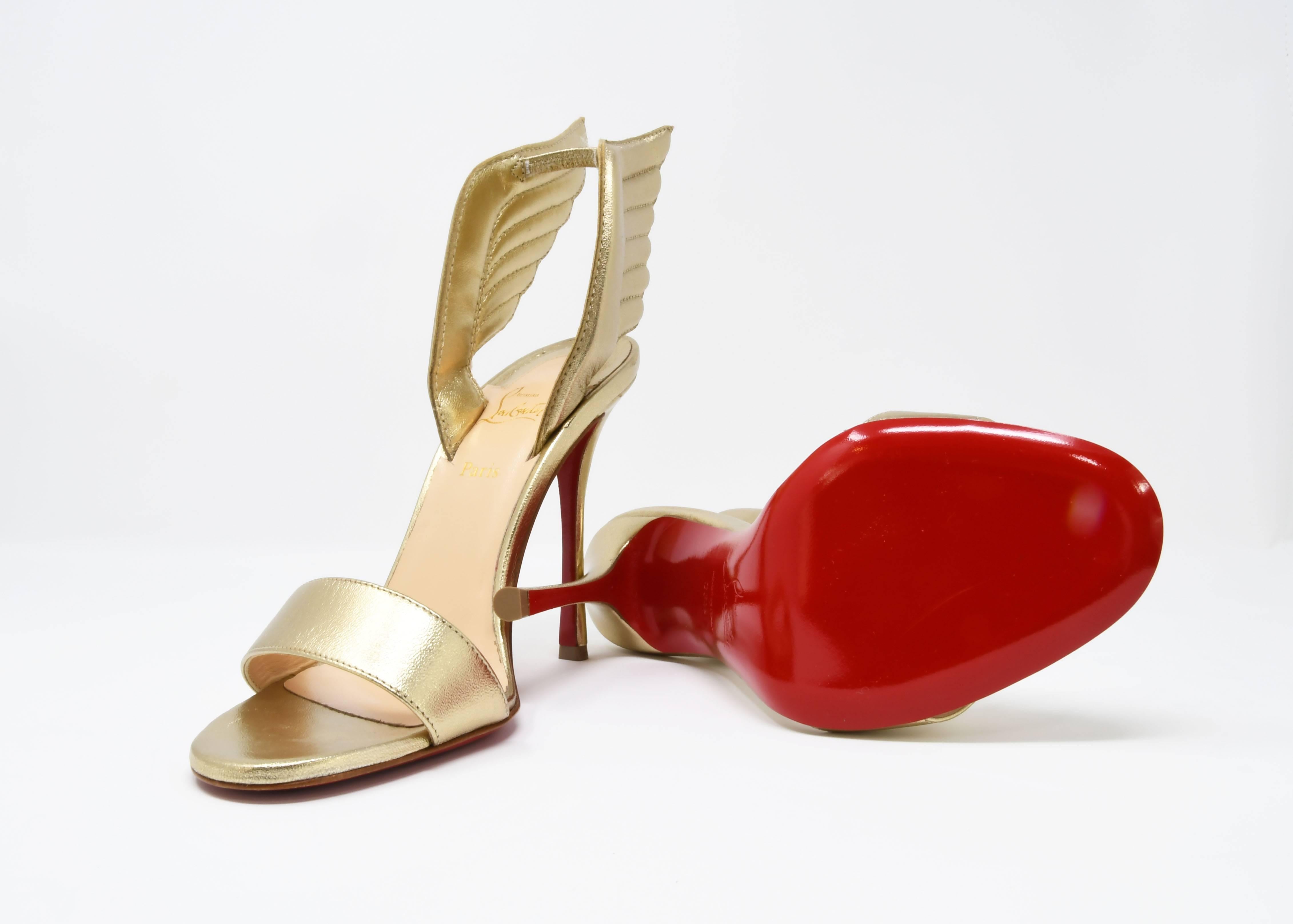 Christian Louboutin Nappa Laminata Samotresse 100 Wings Sandal heels in light metallic gold.  The sandals feature extraordinary wings with a chic peep toe with 4.5 inch heels and red lacquered soles.  Perfect for special occasions.  Dust bags and