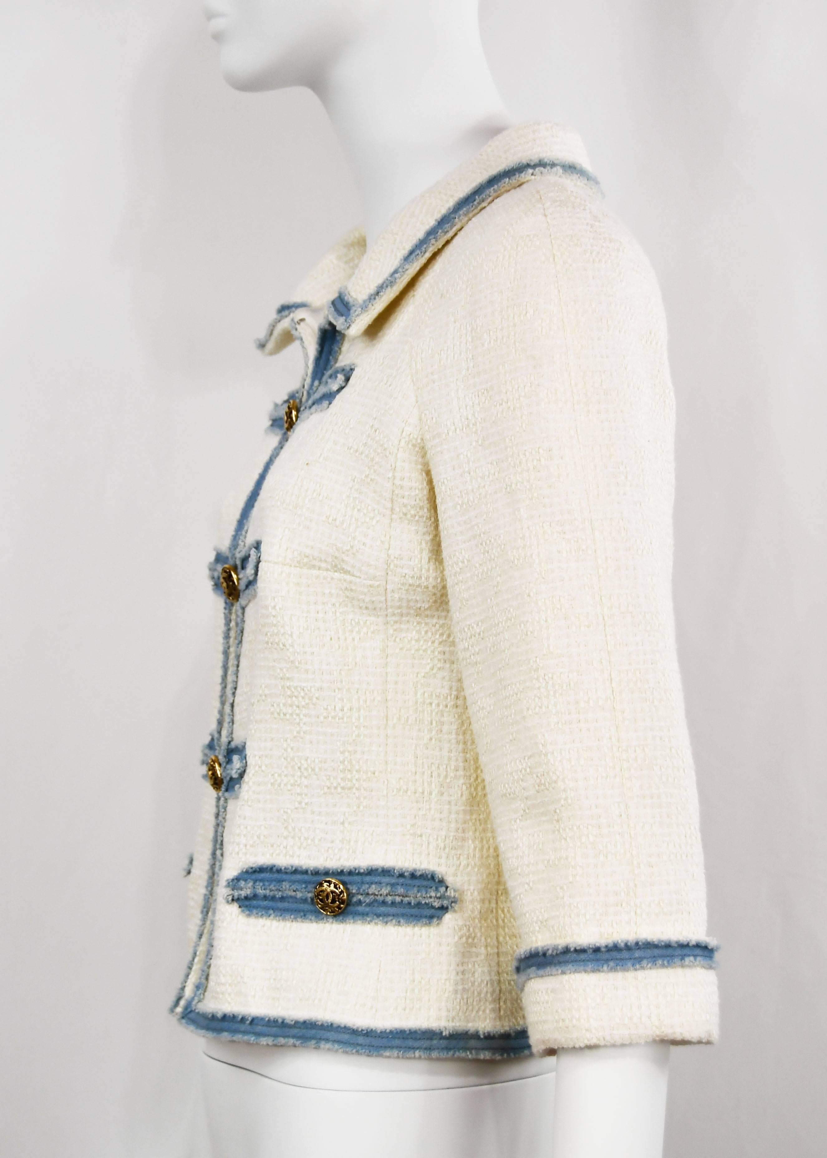 Chanel runway, very rare, elegant white Cotton Boucle Jacket with light denim trimmed frayed detail, FR 36, US 4.  Classic chunky gilt 'CC' buttons down the front.  There are two pockets.  It is lined in silk and the hem is chain weighed.  This item