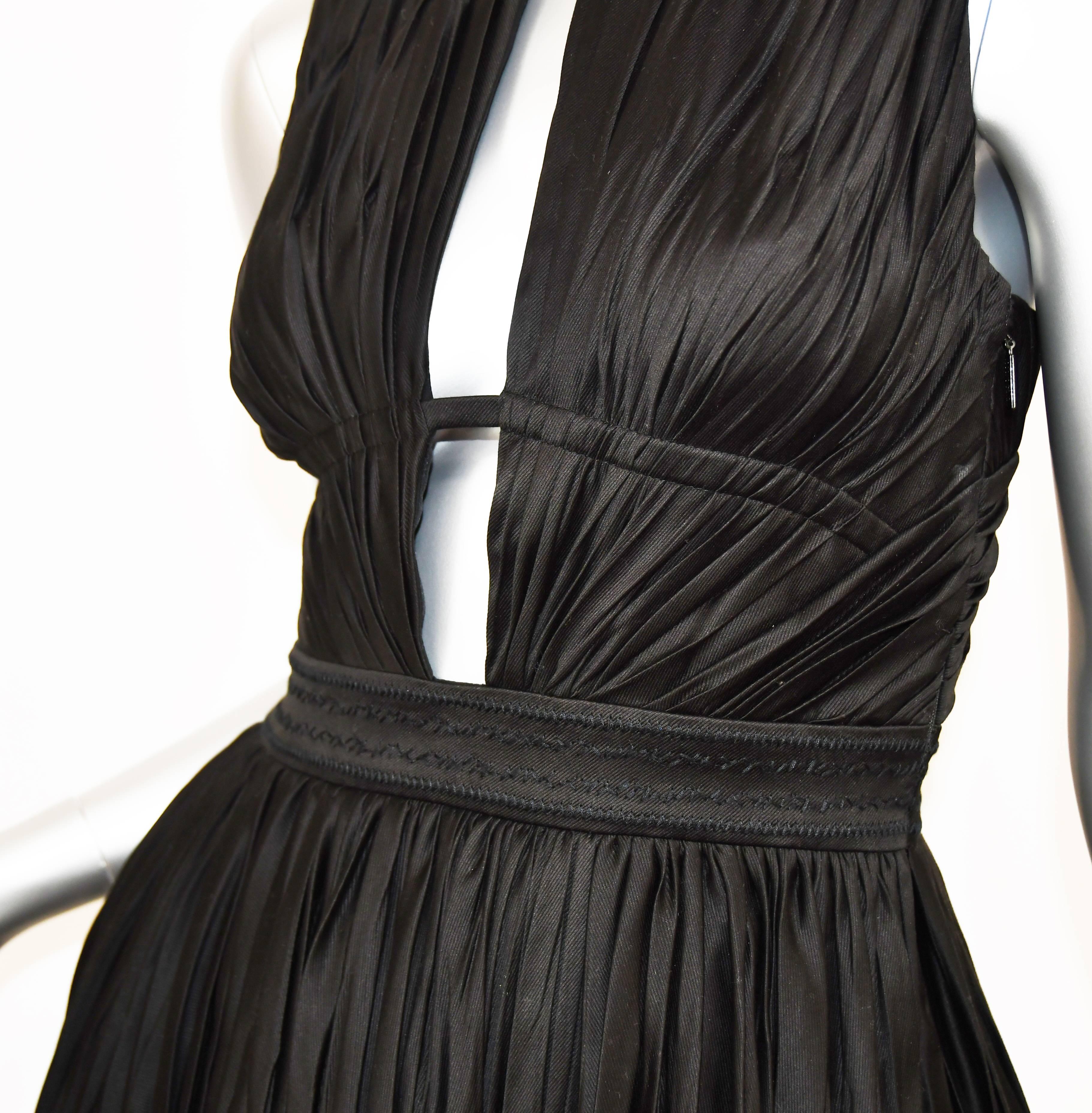 Sizzle in this flirty Roberto Cavalli Cocktail Dress to dance the night away.  Full short skirt with low cut out V-neck front and cut out back gives a sexy float as you move.  Fitted at the waist.  Crinkled taffeta like look to the fabric.  Black.  