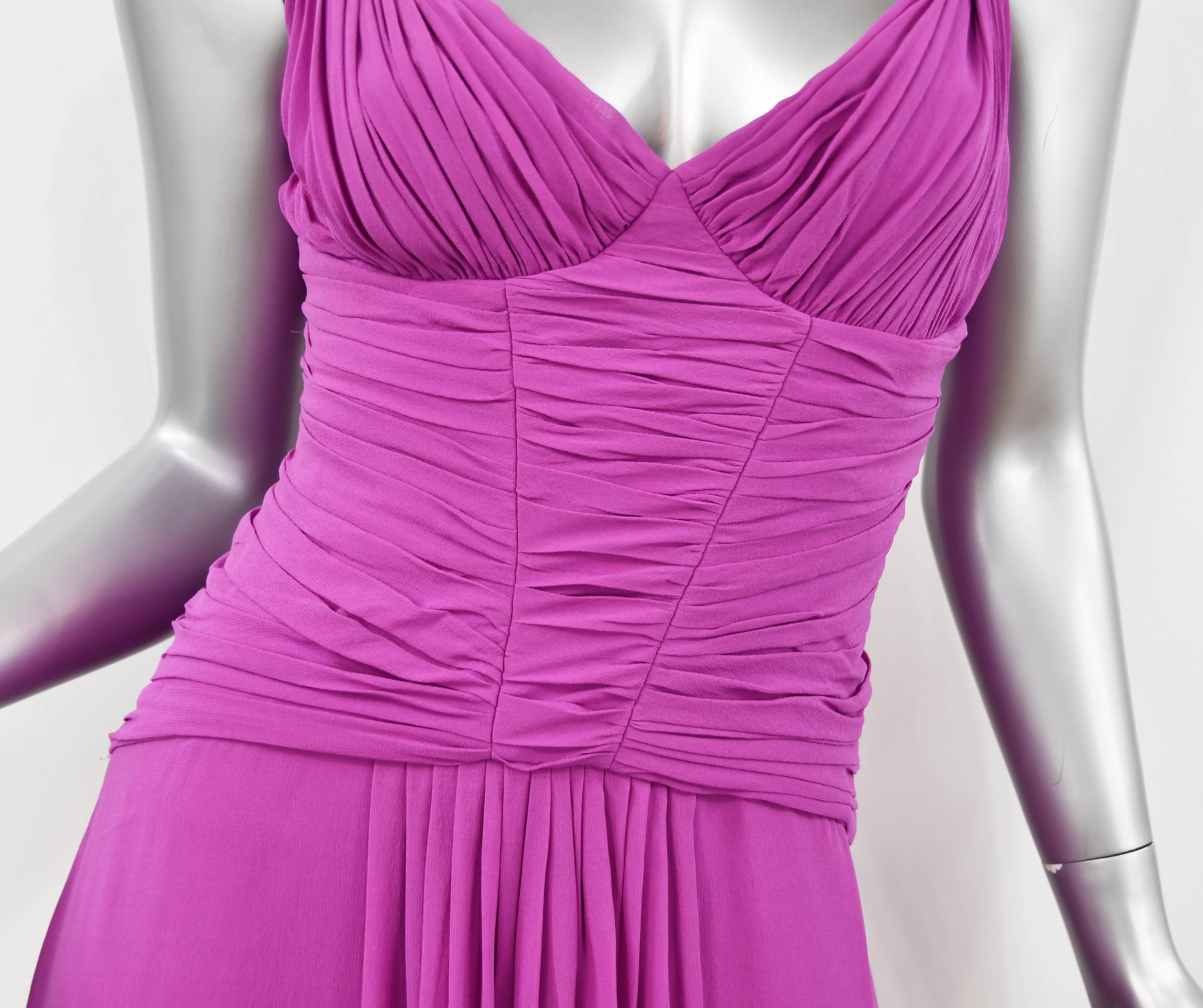 Stunning Emanuel Ungaro silk chiffon gown in eye catching magenta.  Pleated detail adorns the bodice.  The gown drapes beautifully with tucks at the top of the skirt.  A stand out sexy and feminine piece in excellent condition.  Loved on the Red