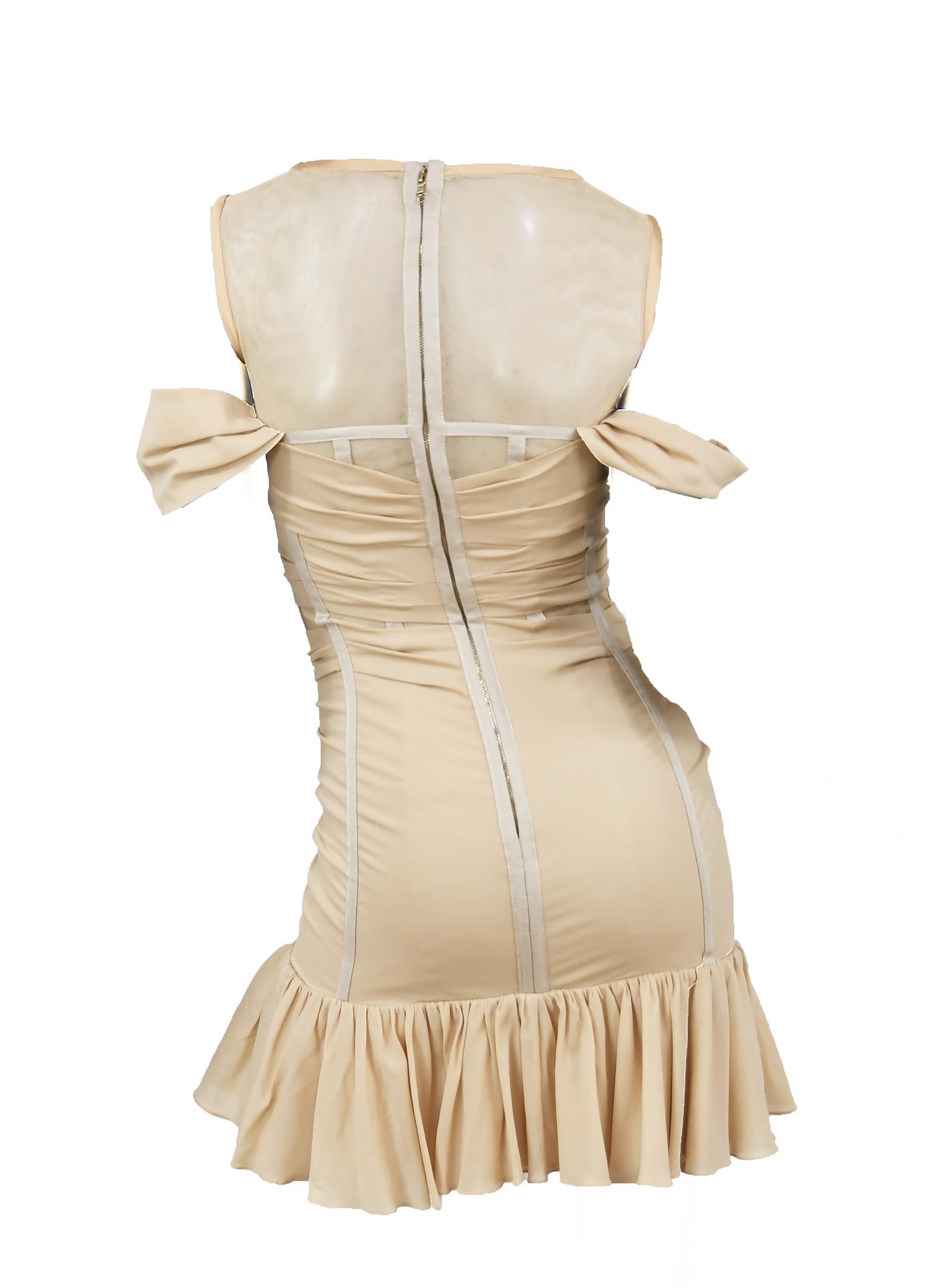 Fun and flirty nude Dolce & Gabbana mini dress.  Mesh bodice with exposed boning and silk ruffled skirt.  Perfect for a night out on the town.  Excellent used condition.