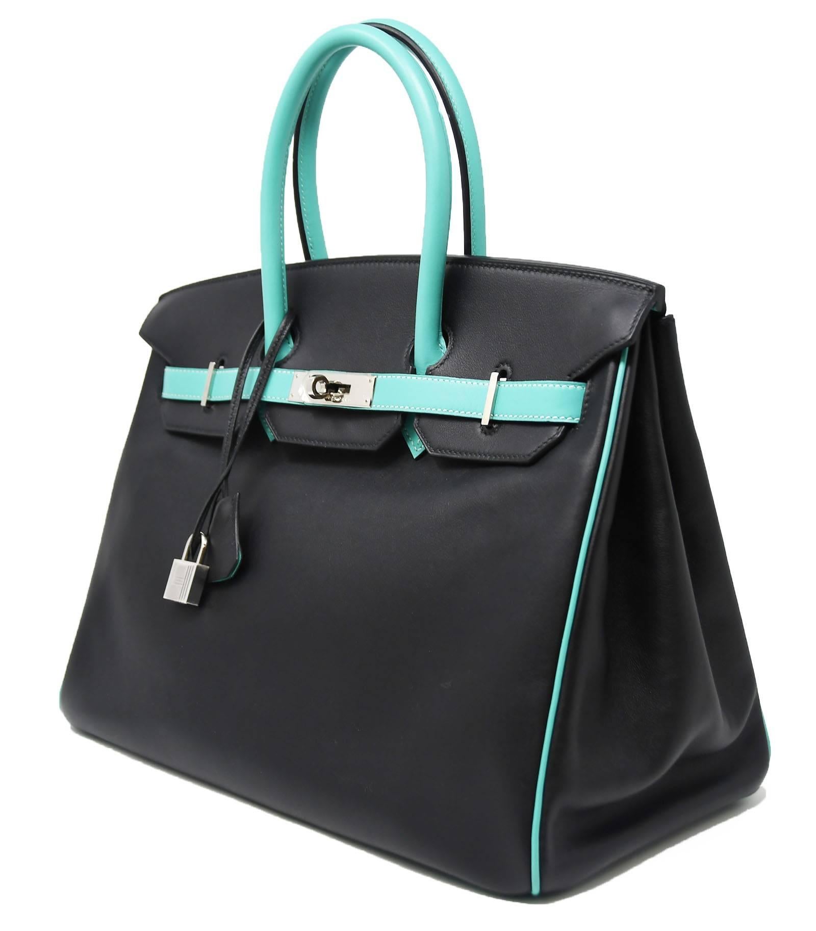 Do not miss out on the opportunity to own this extremely rare horseshoe Birkin bag.  This coveted bicolor bag features a stunning lagoon color and classic black.  Brand new with plastic on the hardware.  A true collectors item.