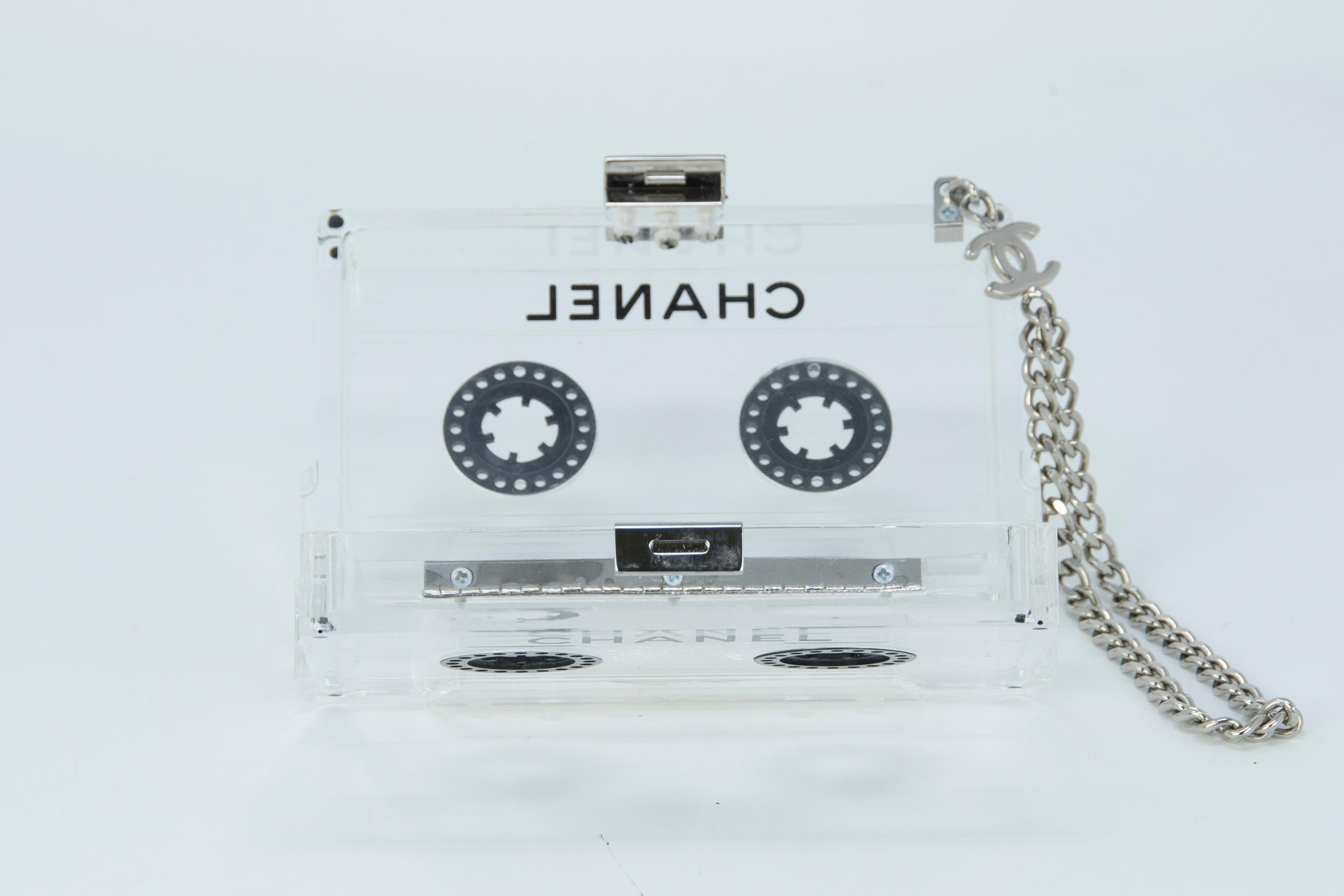 This cassette tape clutch is a true collectors item and a highly coveted piece.  Chanel cassette tape clutch. Featuring a clear lucite exterior emblazoned with black 