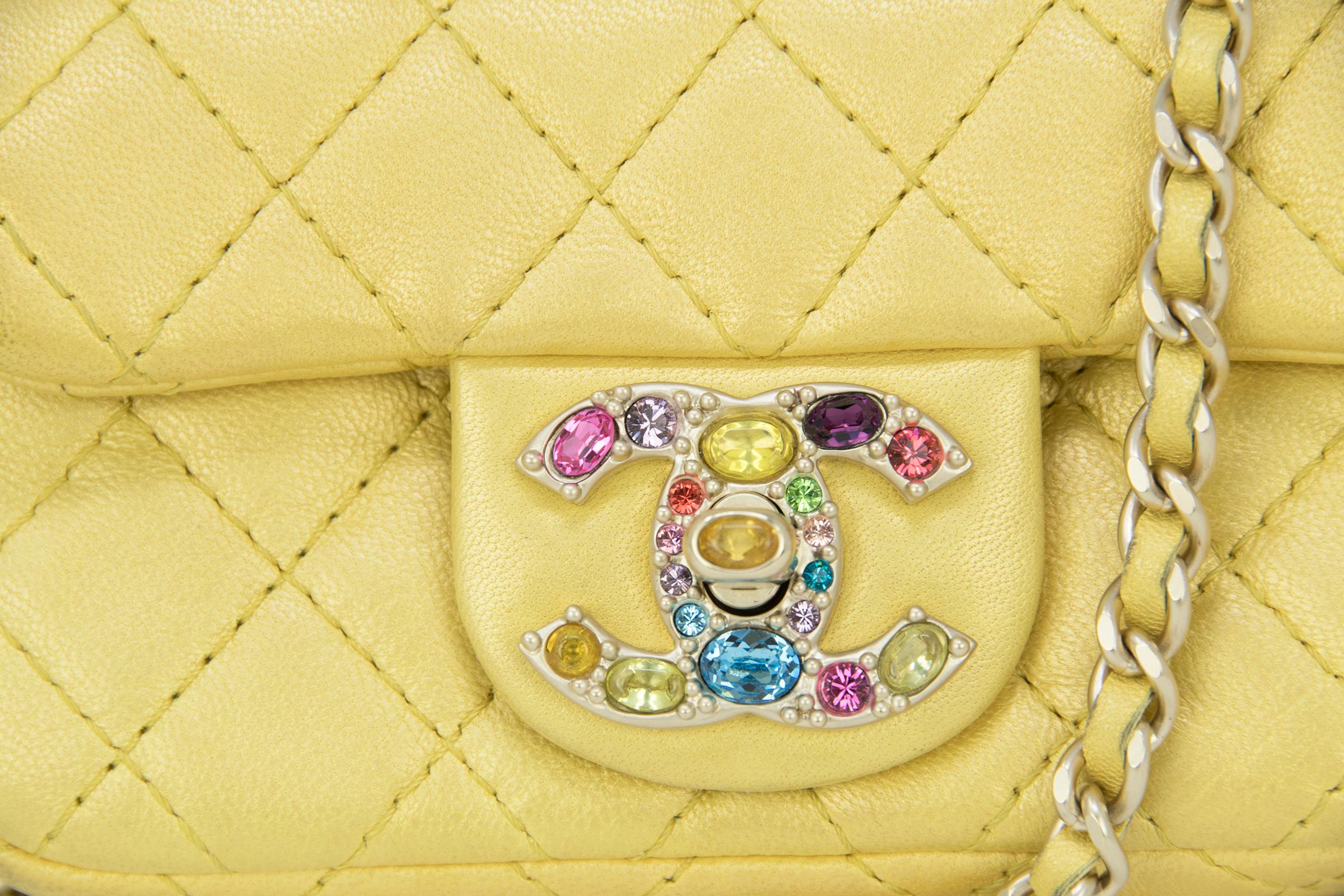 This is an incredible, rare Chanel mini double flap bag.  In a gorgeous shade of yellow with a slight metallic tint, the quilted bag features multicolored rhinestone hardware and a long chain shoulder strap.

Condition: Brand new