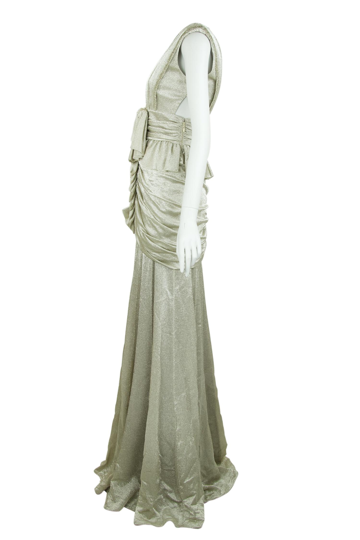 Incredible detail on this silver gown by dutch designer Viktor & Rolf.  Features gathering around the hips with a bow right below the bust.  This dress is breathtaking and will look beautiful at a formal black tie event.

Size: IT 40

Condition: