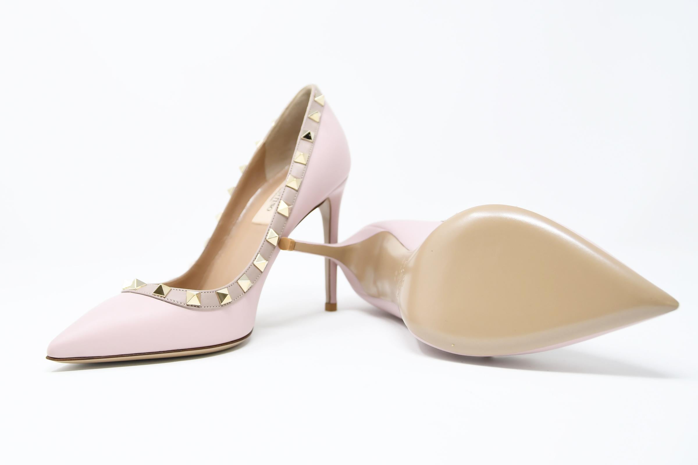 Classic Valentino stiletto in a light pink smooth calf leather with signature gold rock stud design.  Brand new and comes in original box with dust bag.