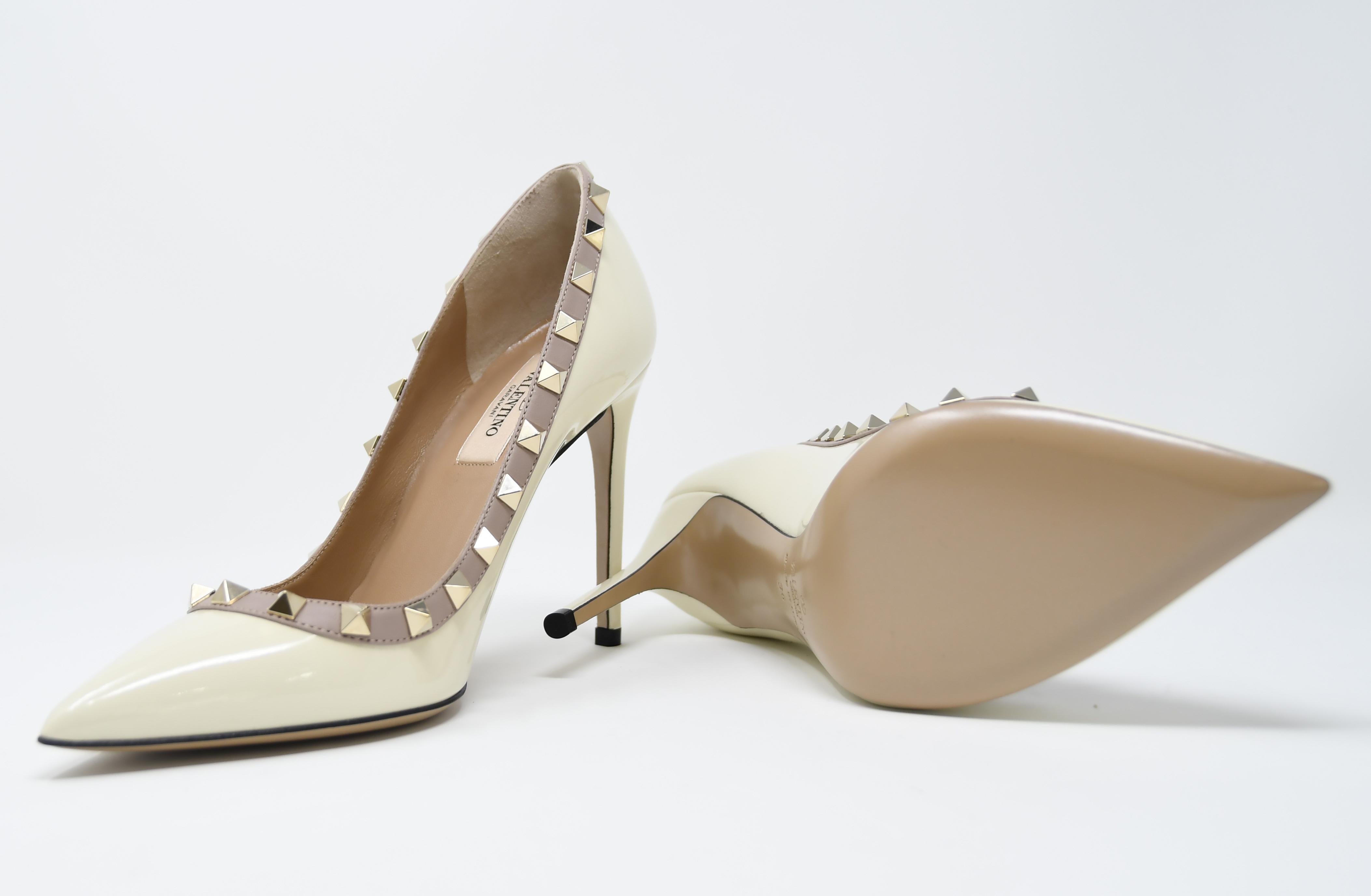 Classic Valentino stiletto in an off white patent leather with signature gold rock stud design.  Brand new and comes in original box with dust bag.