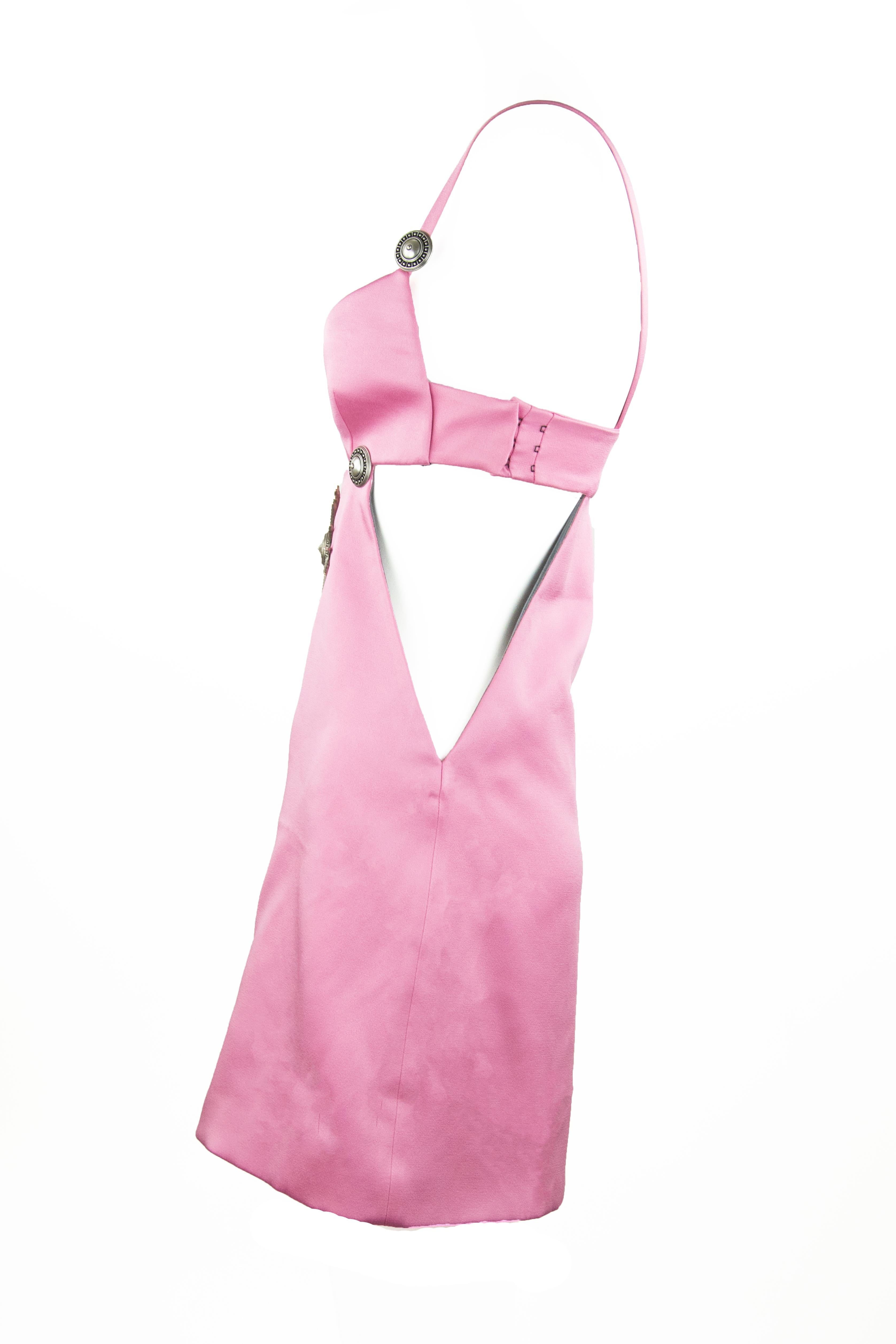 Sexy pink mini dress with cut outs and silver medallions on the bodice.  Features a sheath silhouette.

Size: IT 40

Condition: New without tags

Composition: 79% acetate, 21% viscose

Made in Italy
