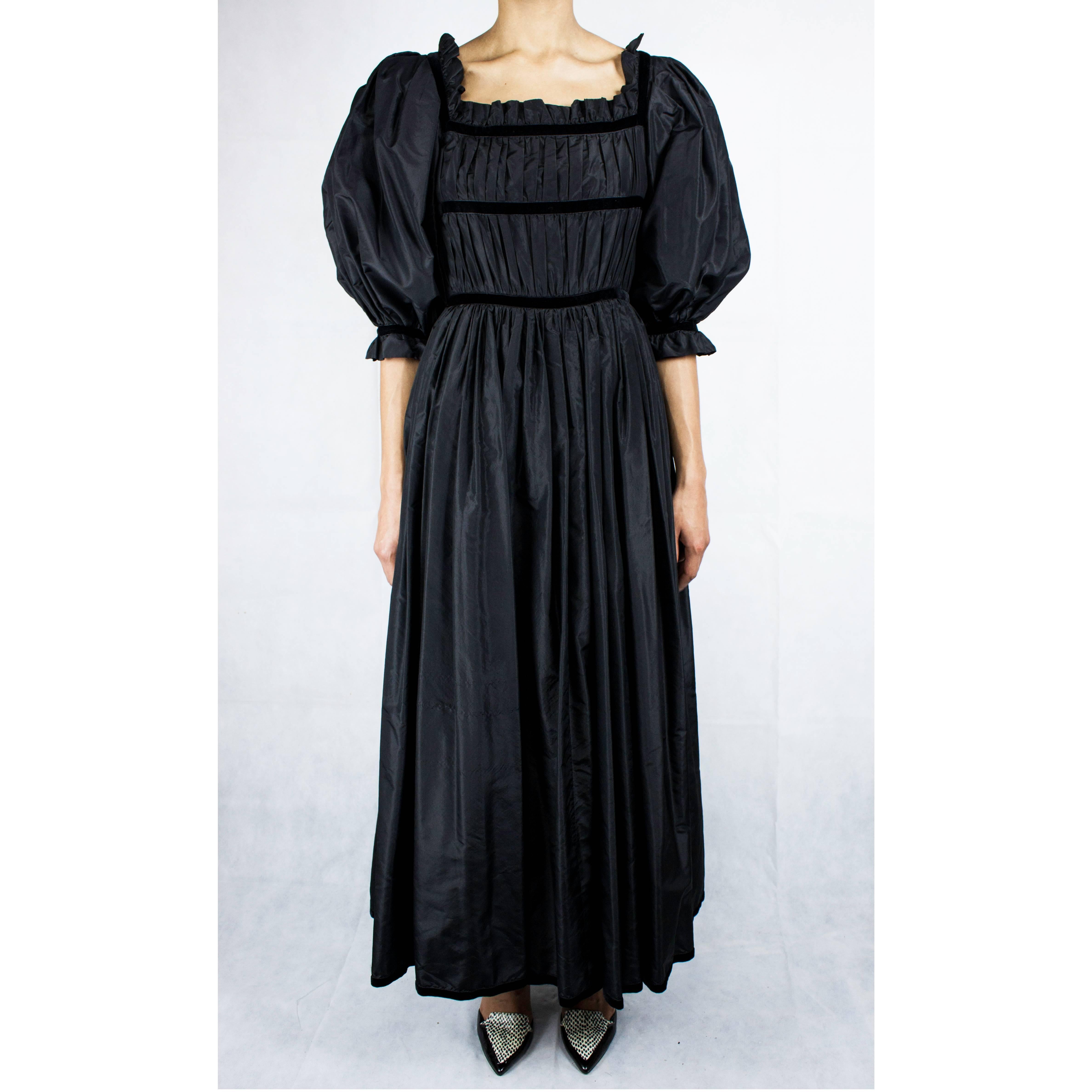 
This beautiful black taffeta evening gown, circa 1970 although quiet in style evokes timeless elegance.
Every details is designed to celebrate unapologetic femininity.
Constructed from opulent taffeta material. The gathered skirt is ample and