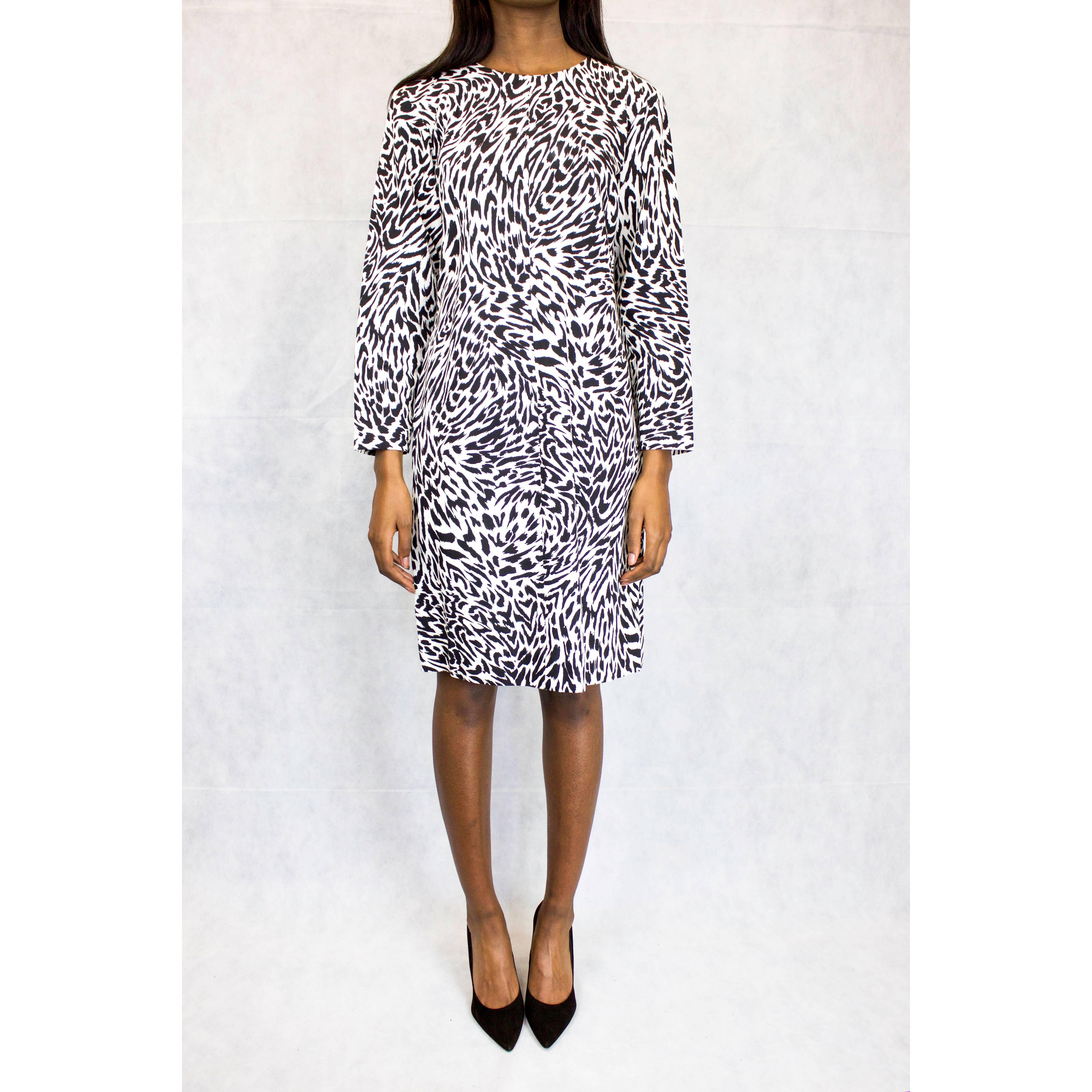 This fun and contemporary slim fitted monochrome animal-esque print dress was designed in  1990 when Saint Laurent was still heading the label. It is constructed from grosgrain (a fine ribbed cotton material). Featuring a zip at the back, a round