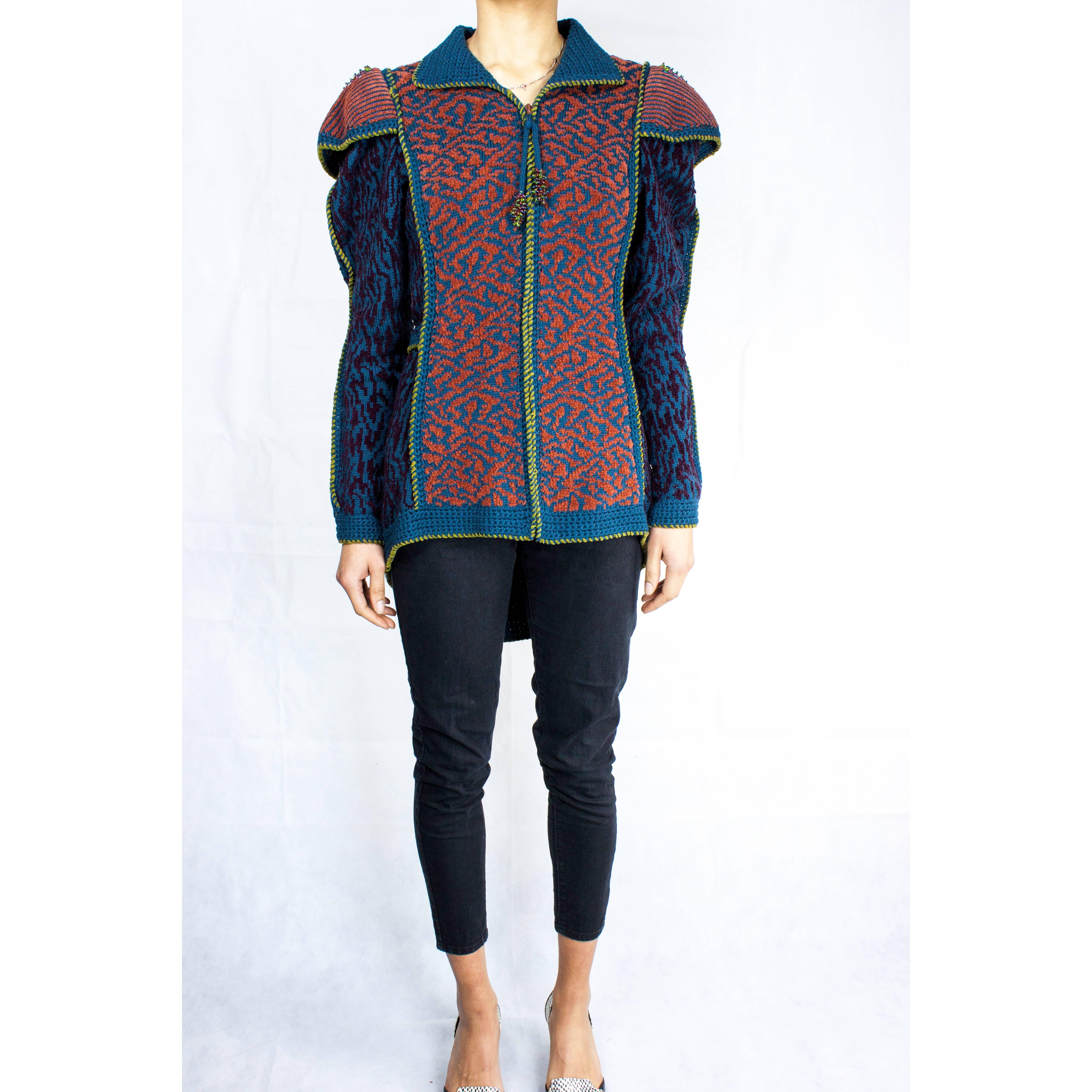 Classic and exuberant style is the way to describe this beautiful jacket.

Anne Fewlass creates unique, elaborate, and richly coloured knitwear inspired by historical designs.

In this design Anne Fewlass uses intricate decorative panels constructed