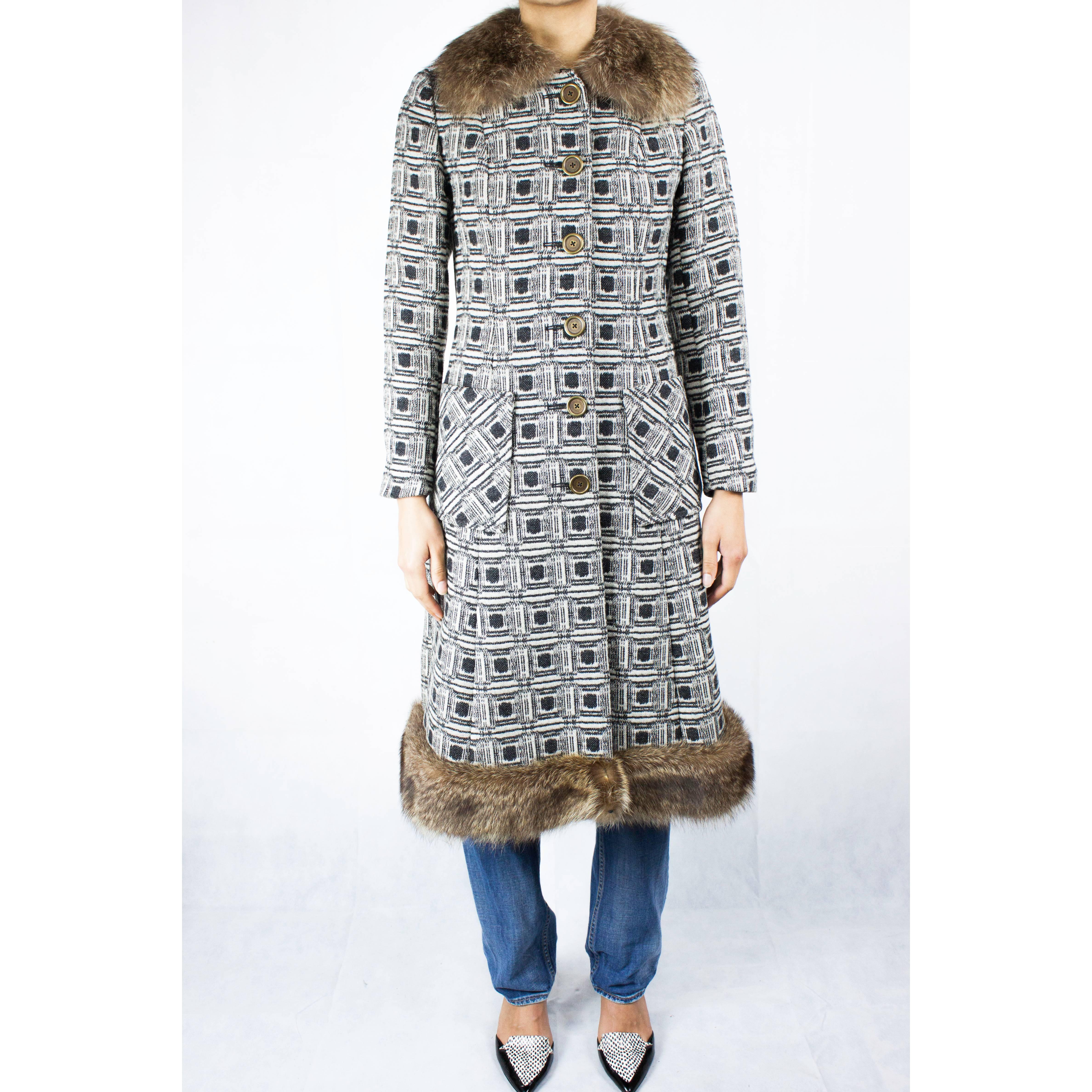 This wool coat is a delight of squares, dots and lines. This geometric patterned coat is constructed from a wool cloth. It has a classic 1960s slim silhouette. Featuring single breasted closure that fastens to the front with metal buttons.