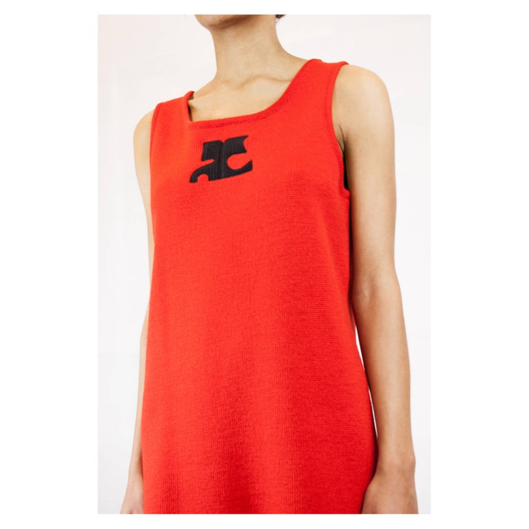 This contemporary wool knitted tunic dress is constructed from simple stockinette stitches. Ribbing on both the round neckline and the sleeveless arm holes. It features a blue appliqué of the Courréges logo.

The shape and colour of this tunic are