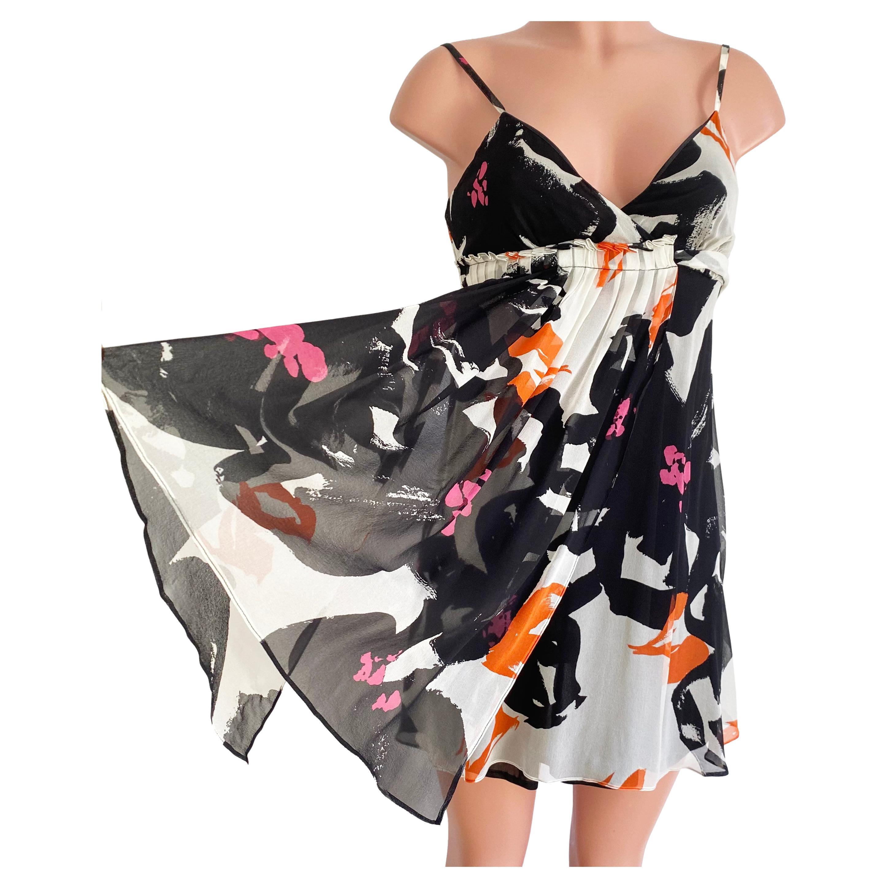 Black and orange red free-hand floral on white silk georgette.
Wear it on its own, with a cardigan or even a Biker jacket. With stilettos, flip flops, or ankle booties! 
This versatile little dress travels and packs beautifully and will make you the