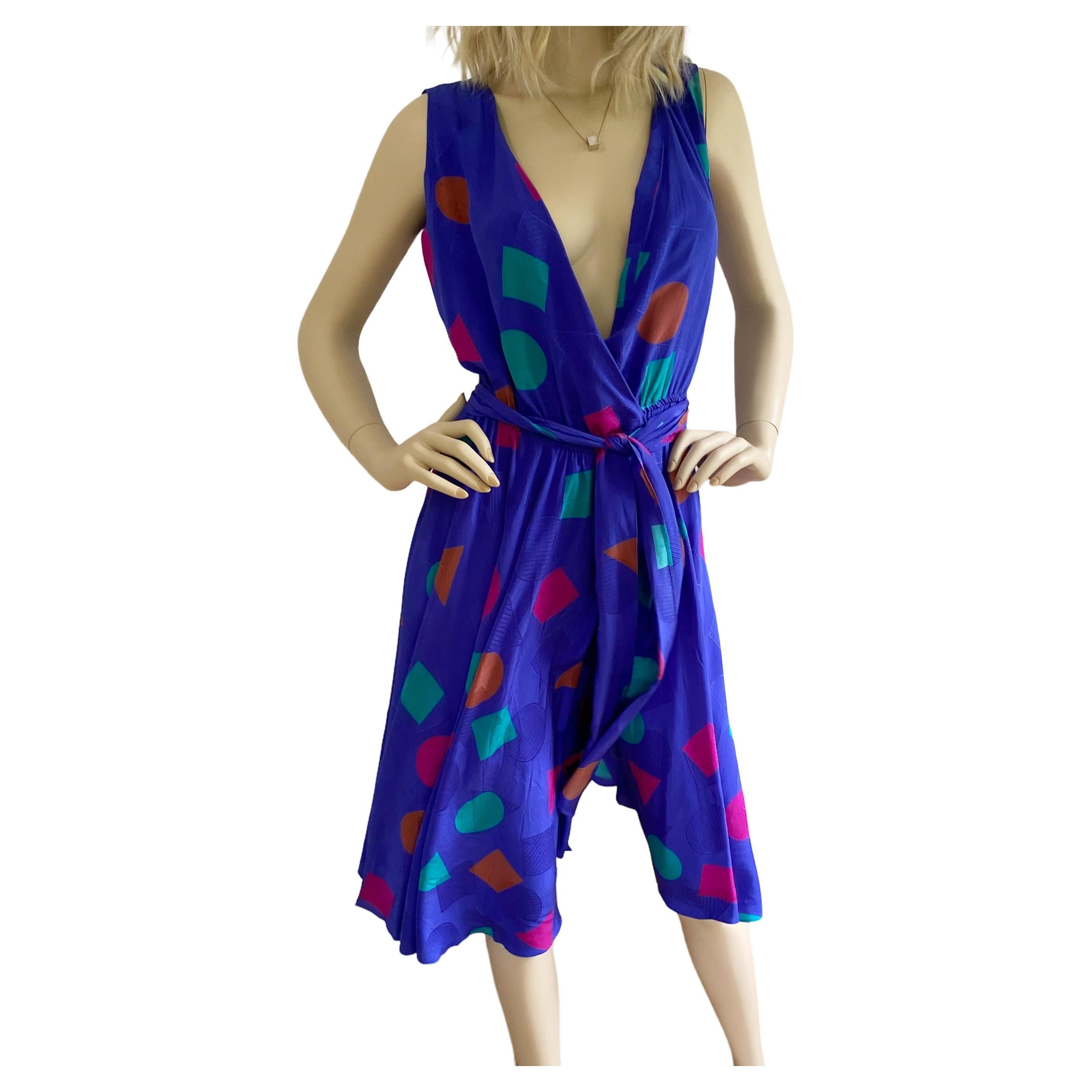 Flora Kung blue silk wrap Selma dress.
Bias-cut skirt.
Elastic waist true wrap. Easy fit.
Original print on Flora's original geo silk jacquard. 
Size 4
17