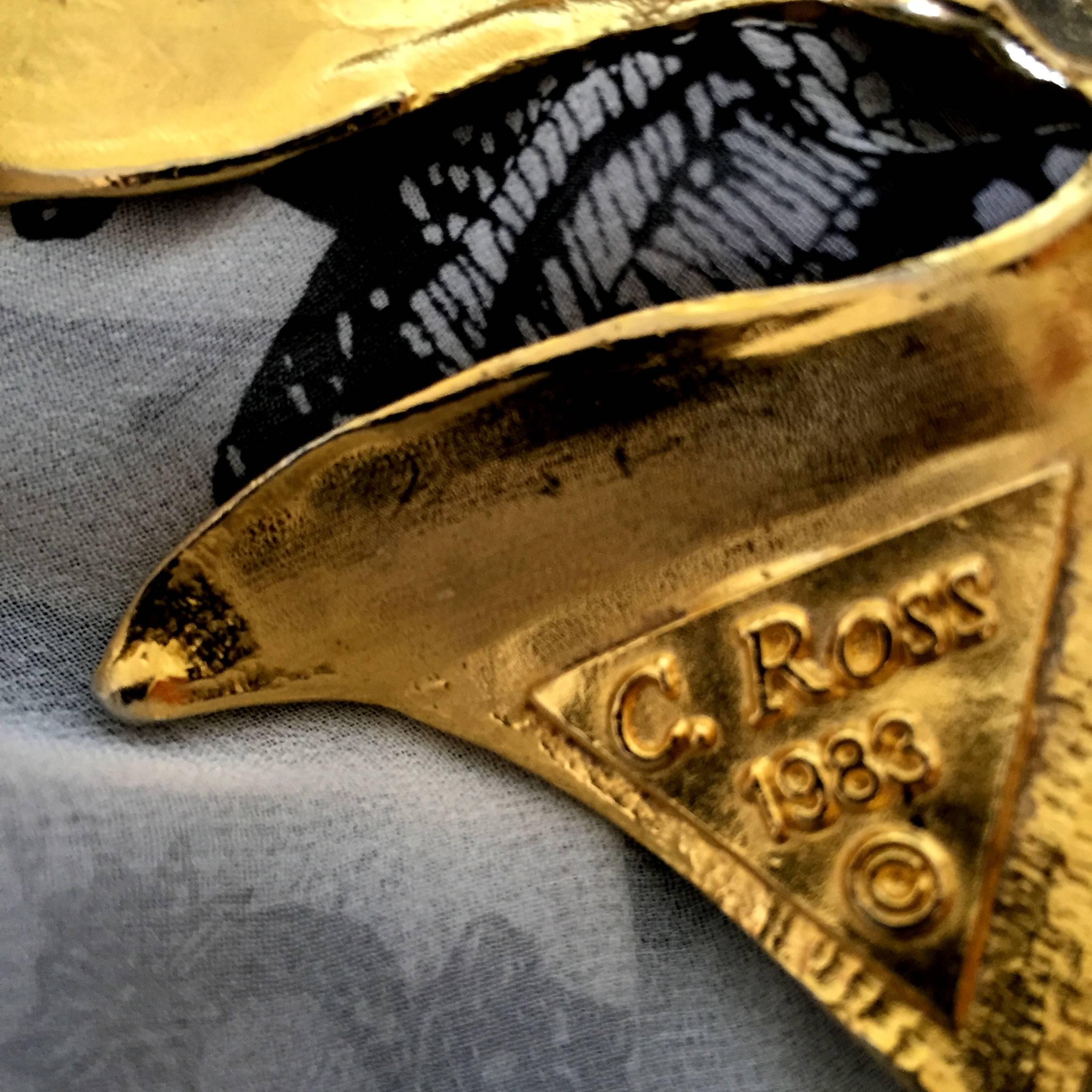 Circa: 1983
Material: Metal, 24 K gold gilt
Size: 3.75" L X 5.5" W 
Condition: Very good. No discoloration 
 
Born in Manhattan, New York, established sculptor Christopher Ross envisions a belt as wearable art, a sculptural jewel destined