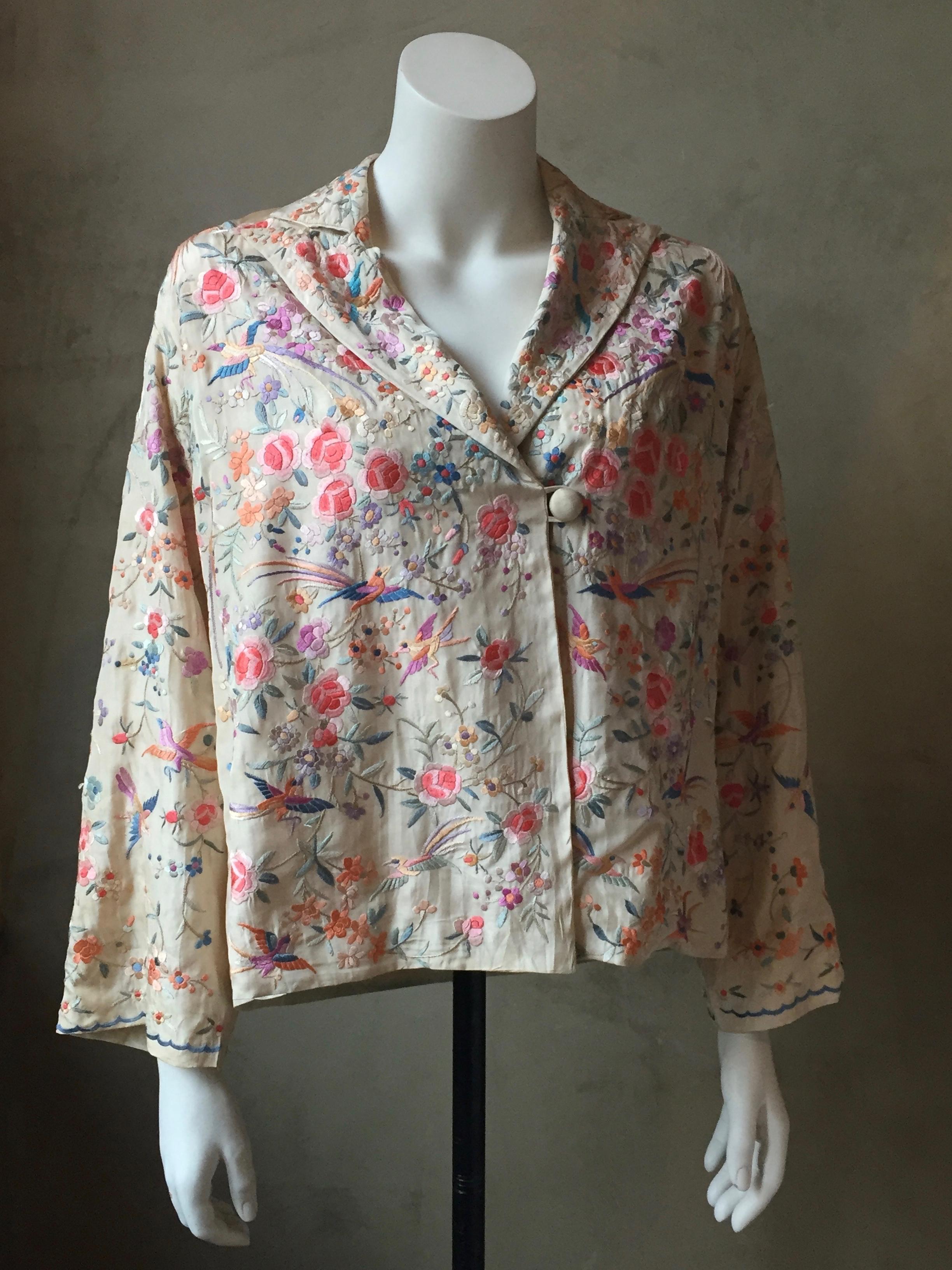 Lovely Cantonese Ivory silk jacket hand embroidered in pastel shades of silk floss .
Made Canton china in a European style to suit the taste of a most elegant lady in the 1920's.
Fully lined in silk crepe. 
shoulder width(slightly dropped shoulder
