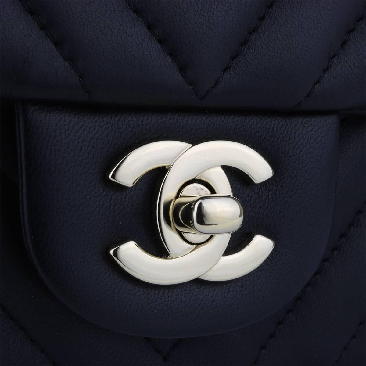 Authentic CHANEL Classic Square Mini Chevron Black Lambskin with Light Gold Hardware 2017.

This stunning bag is still in pristine-brand new condition-with original tag still attached. The bag still holds the original shape and hardware still shiny,
