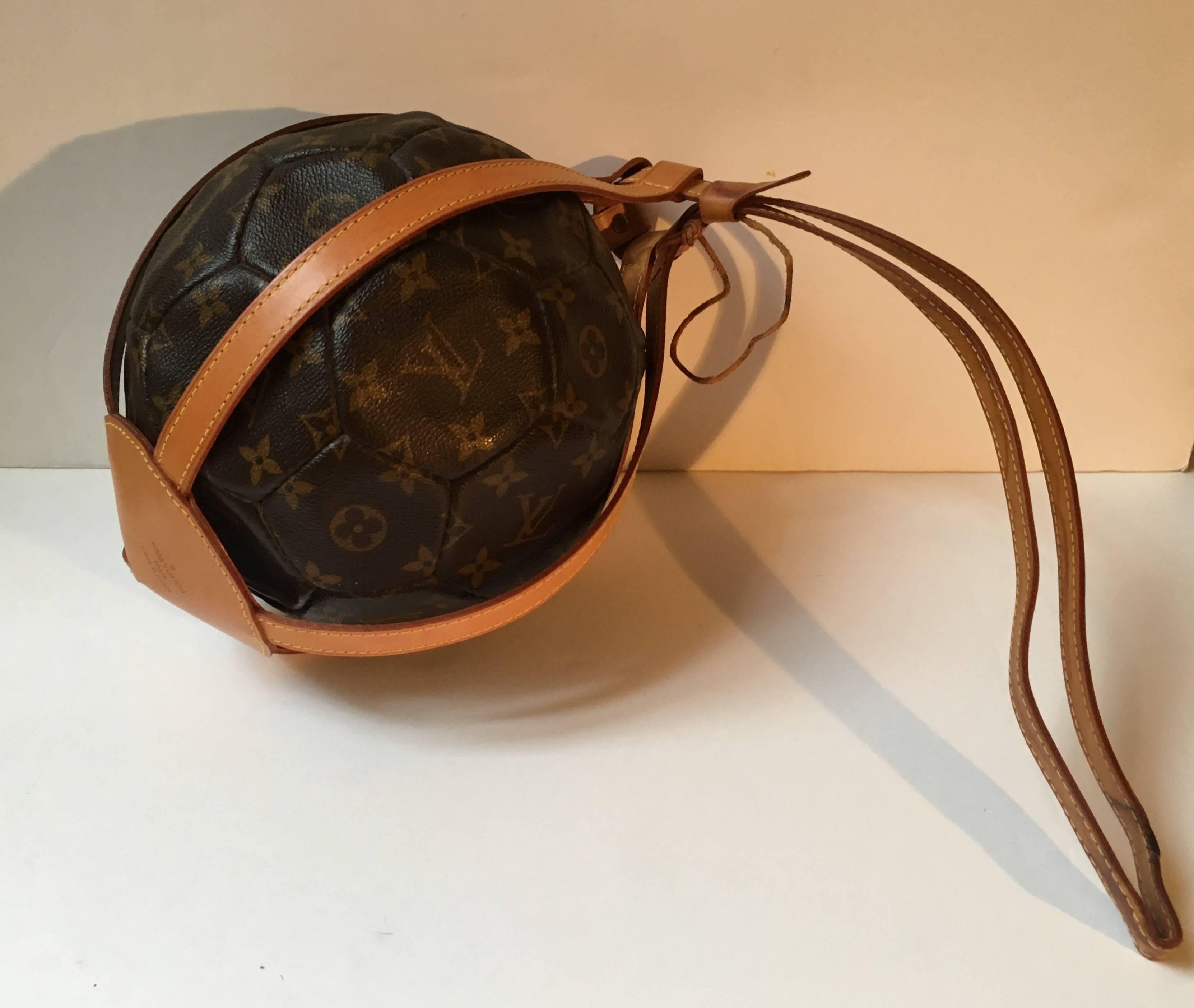 Louis Vuitton rare Leather Soccer Ball, World Cup France 1998 Limited Edition 
Cowhide cone shaped carry holdall/strap and Ball both emblazoned  with the Louis Vuitton in Gold (Louis Vuitton Paris and France 1998 on the ball base ) and both engraved