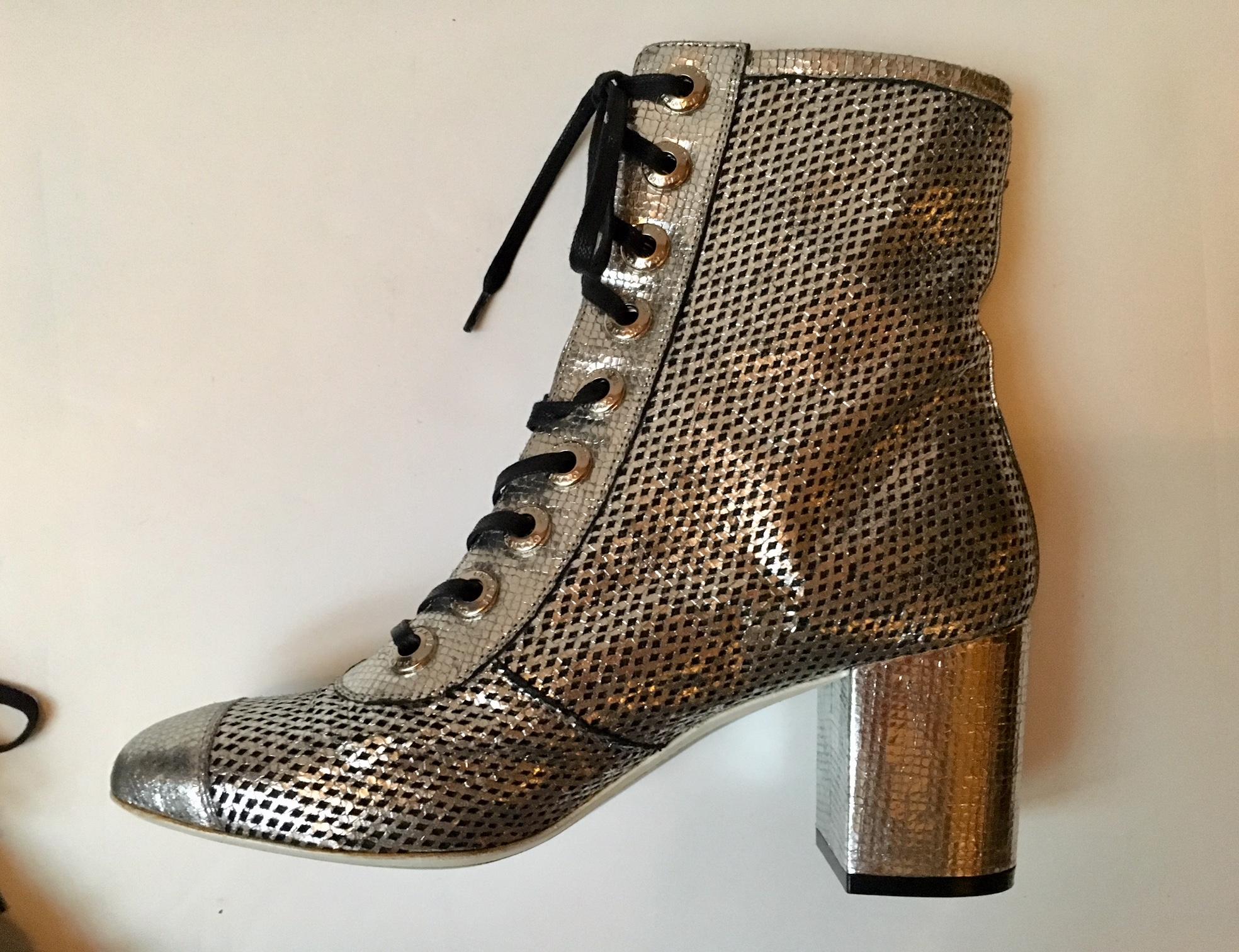 A pair of  Chanel Silver net Leather laced  Boots .Made of pierced leather in metallic white  gold leather.
- laser cut leather 
- rounded cap-toes
- chunky heel
- black cord lace-up ties 
worn only for the 2008 spring summer show .
bearing the