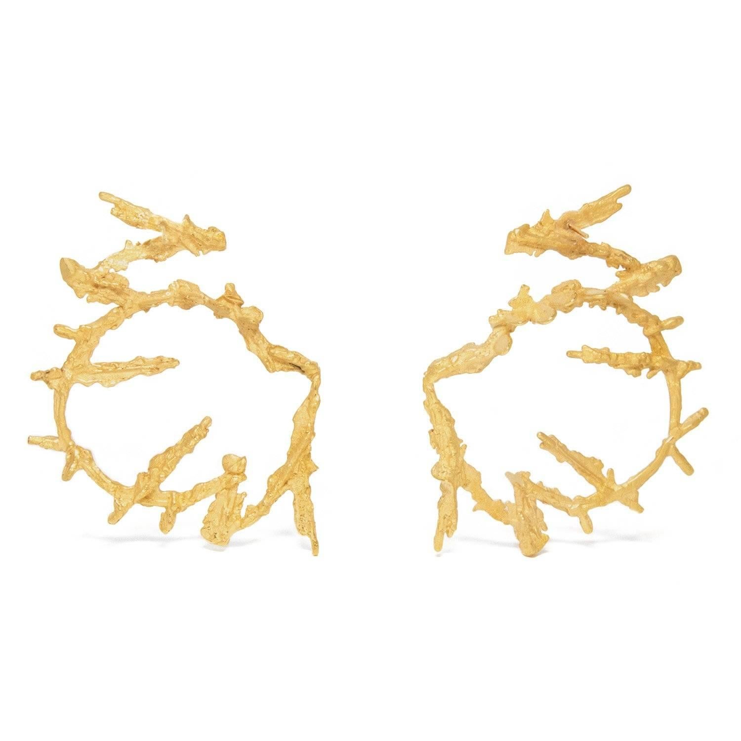 Maze: Passages and paths constructed as a puzzle.

Hoop earrings are in style at the moment, and I have jazzed-up the trend with these super-sized shapes, formed of textured rings contrasted with needle-like fragments. These features all combine to