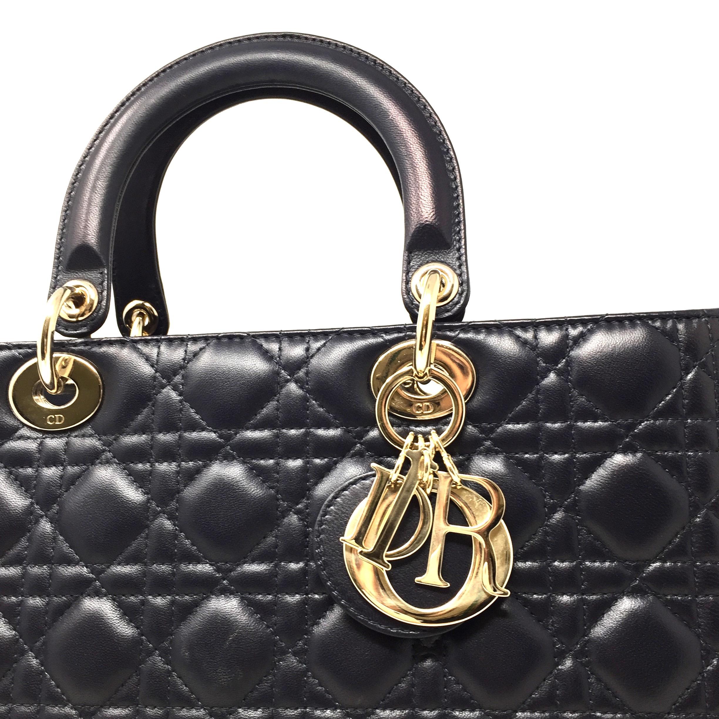 The Lady Dior tote Crafted from blue leather, this tote carries a cannage pattern exterior. It is equipped with dual rolled top handles, classic Dior letter charms and protective metal feet. The top zip closure opens to a spacious nylon lined