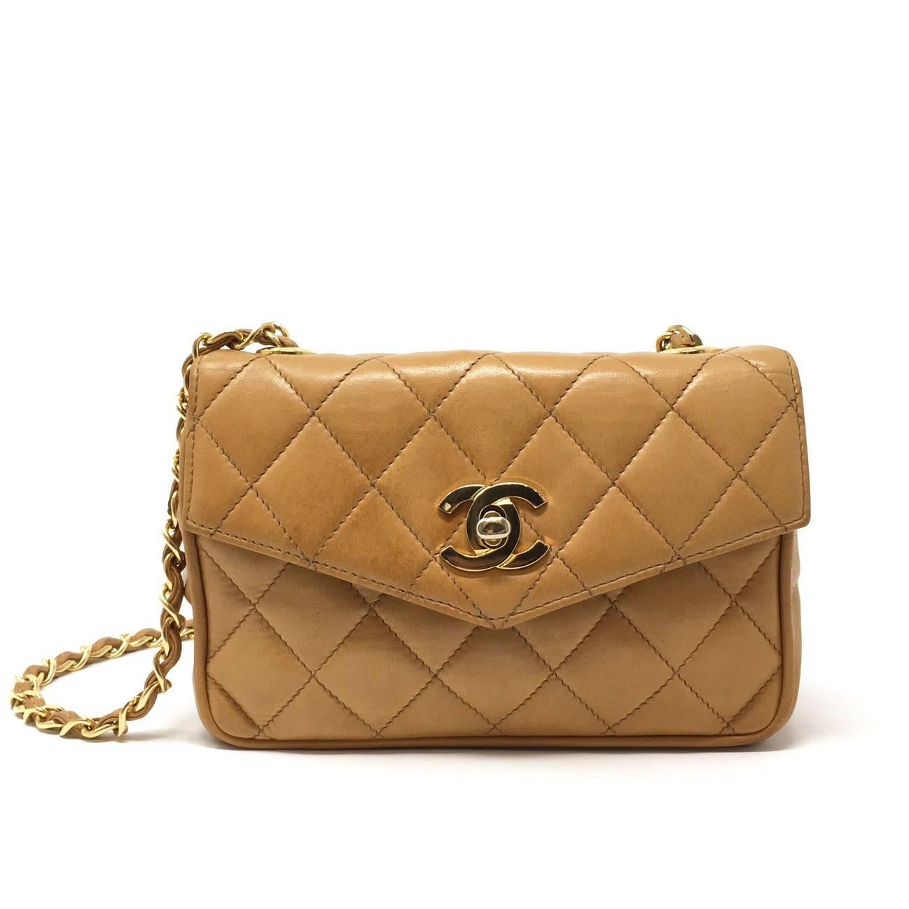 Delicious Vintage 80s Chanel Biscuit Colour Lambskin Matellasse' Mini Flap Shoulder Bag. Classic Gold-Plated CC Logo Twist Closure Opens Single Flap Style. Long Woven Chain And Leather Shoulder Strap. Identification  Vintage Code Inside. The Bag is