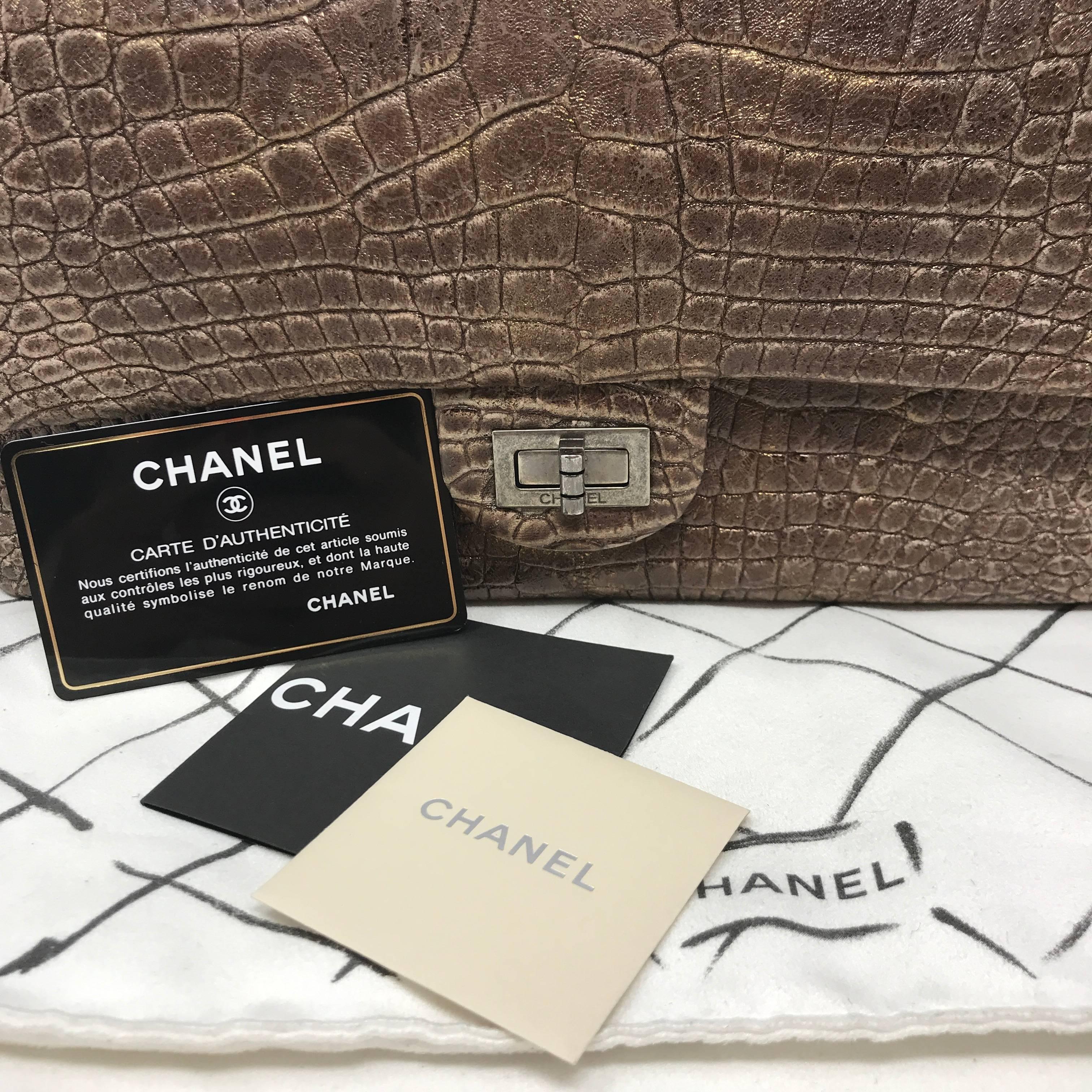 Chanel metallic bronze classic double flap bag of alligator leather with ruthenium tone hardware. This bag a front flap with signature  turnlock closure, half moon back pocket and an adjustable ruthenium tone chain link. The interior is lined in