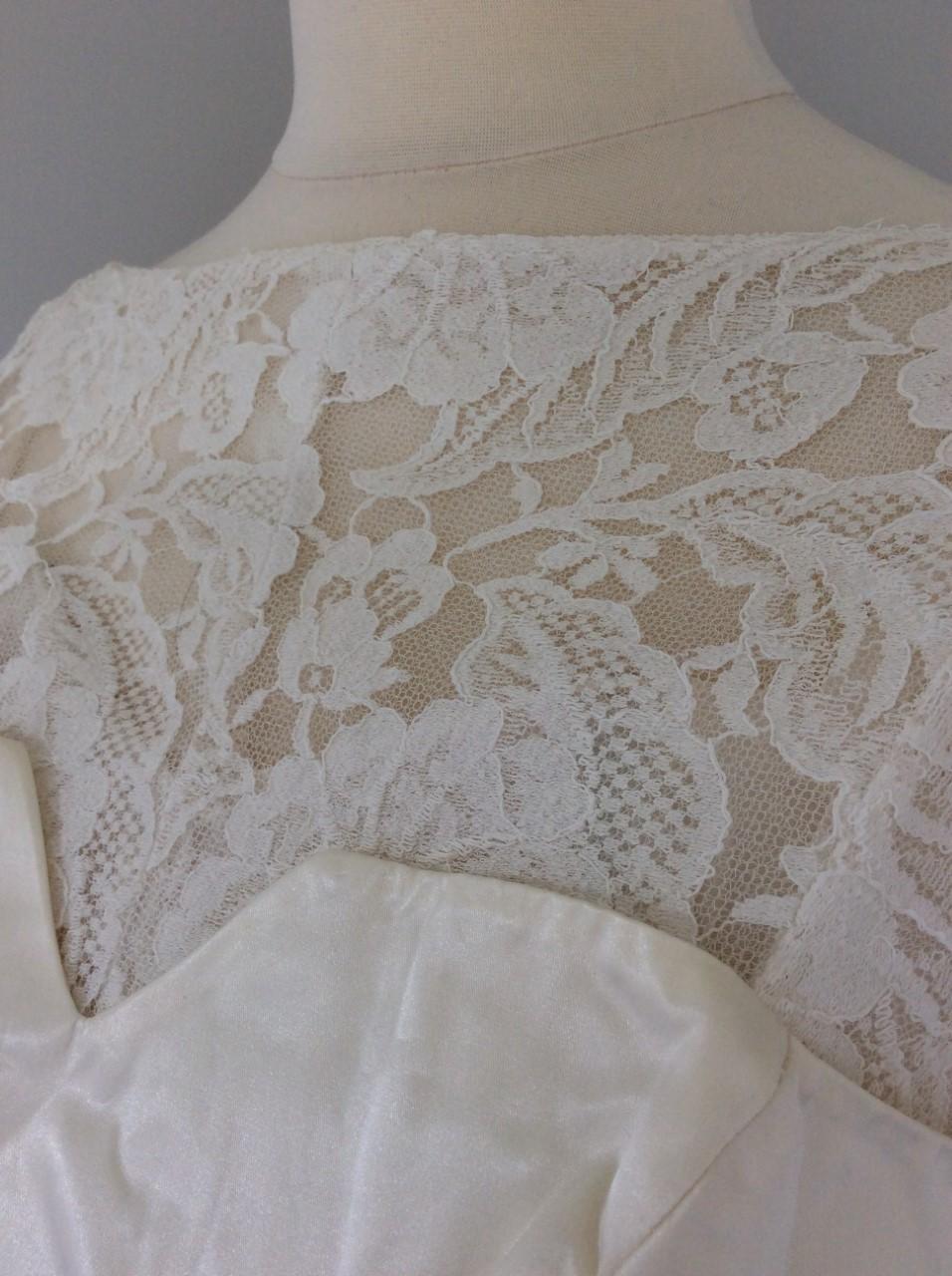 Vintage 1970's custom made cream wedding gown / occasion dress Cream floral lace fabric over cream polyester lining which is boned at the bust and has shoulder straps.  Shaped, ‘satin’ fabric overlay to bustline - lace above is unlined.  Boat