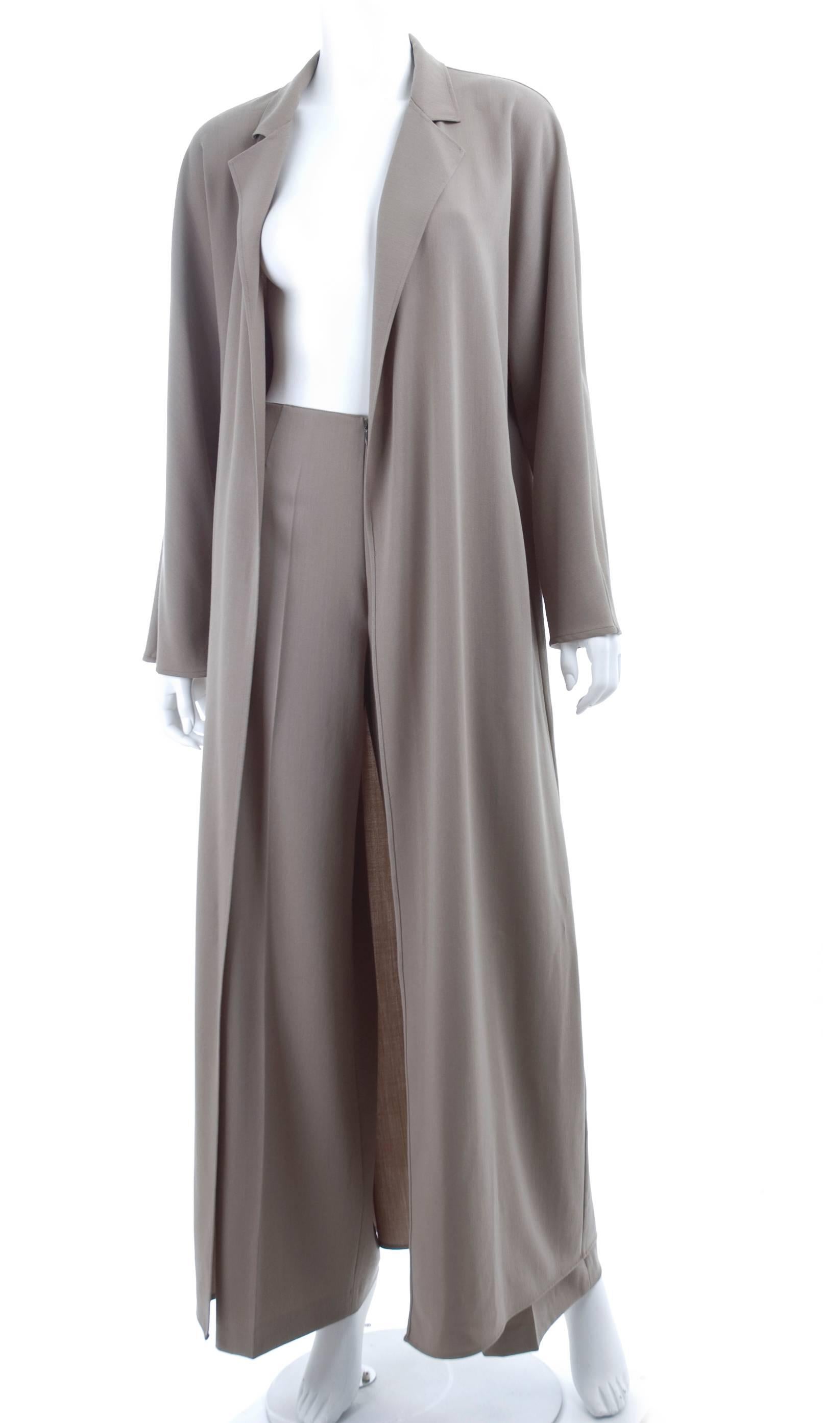 1980s KRIZIA strait long coat and wide leg pants ensemble.
The coat is unlined and the pants zipp up in the front without waistband.
Fine virgin wool in color taupe.
Excellent condition - no flaws to mention.
Size 42 Italy
Measurements:
Coat