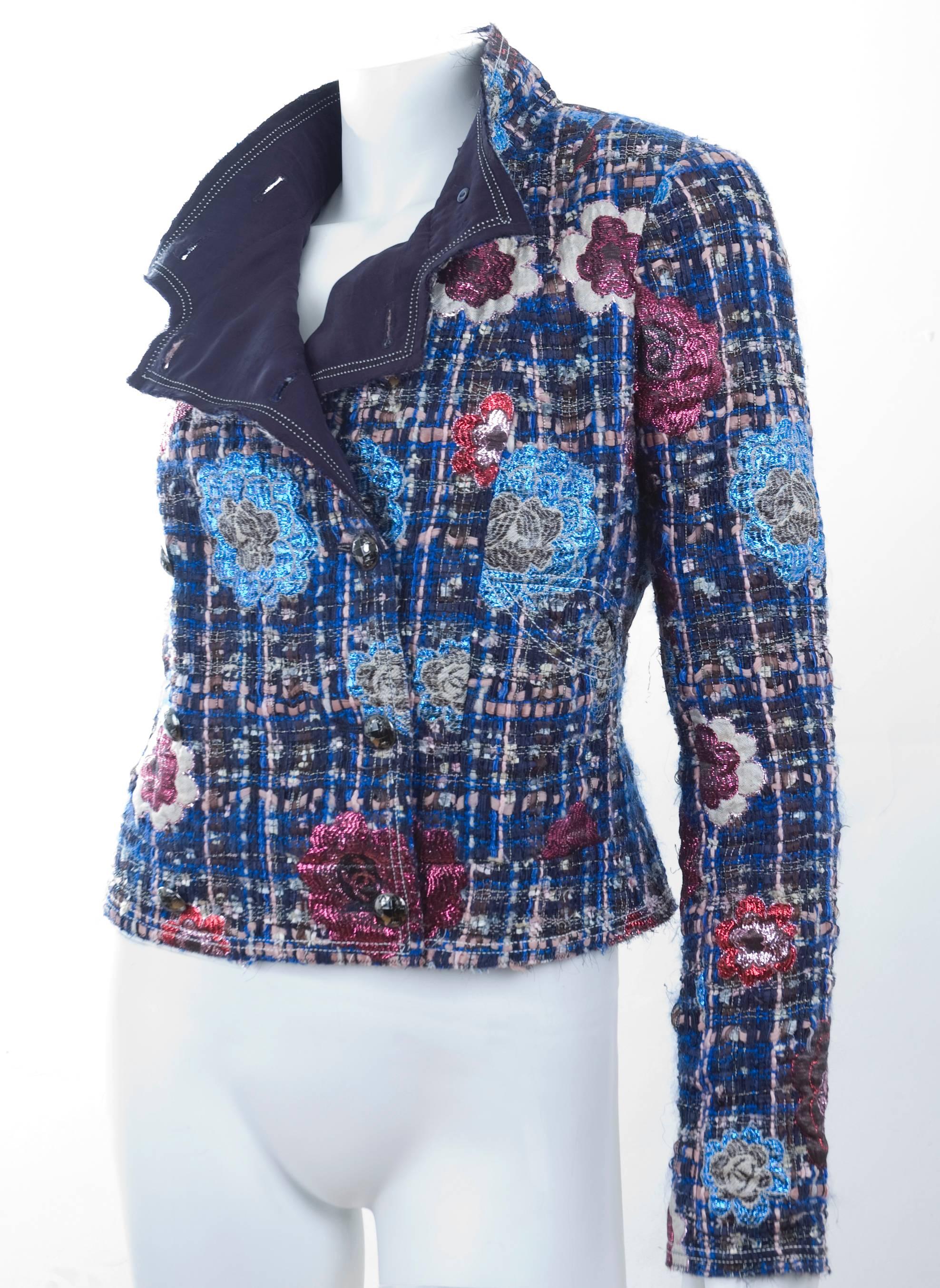 Chanel Jacket in blue and pink bouclé fabric and metallic camellias. Raw edges and lining in navy silk. Buttons in silver and black with CC logo and world-map.  Size 36 EU
Retail was 5300 Euros.
Excellent condition - no flaws to